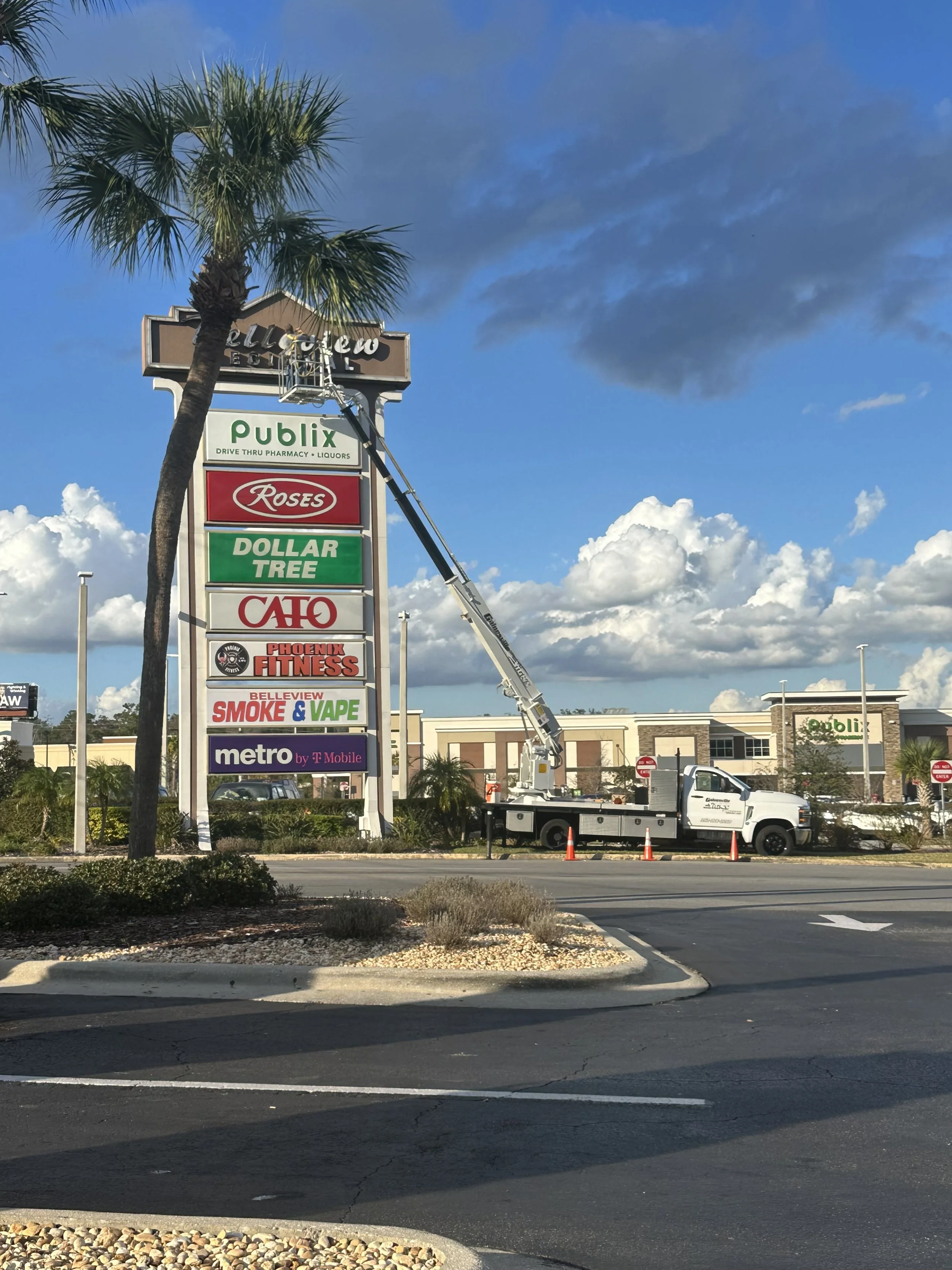 Strip mall sign displaying multiple business names