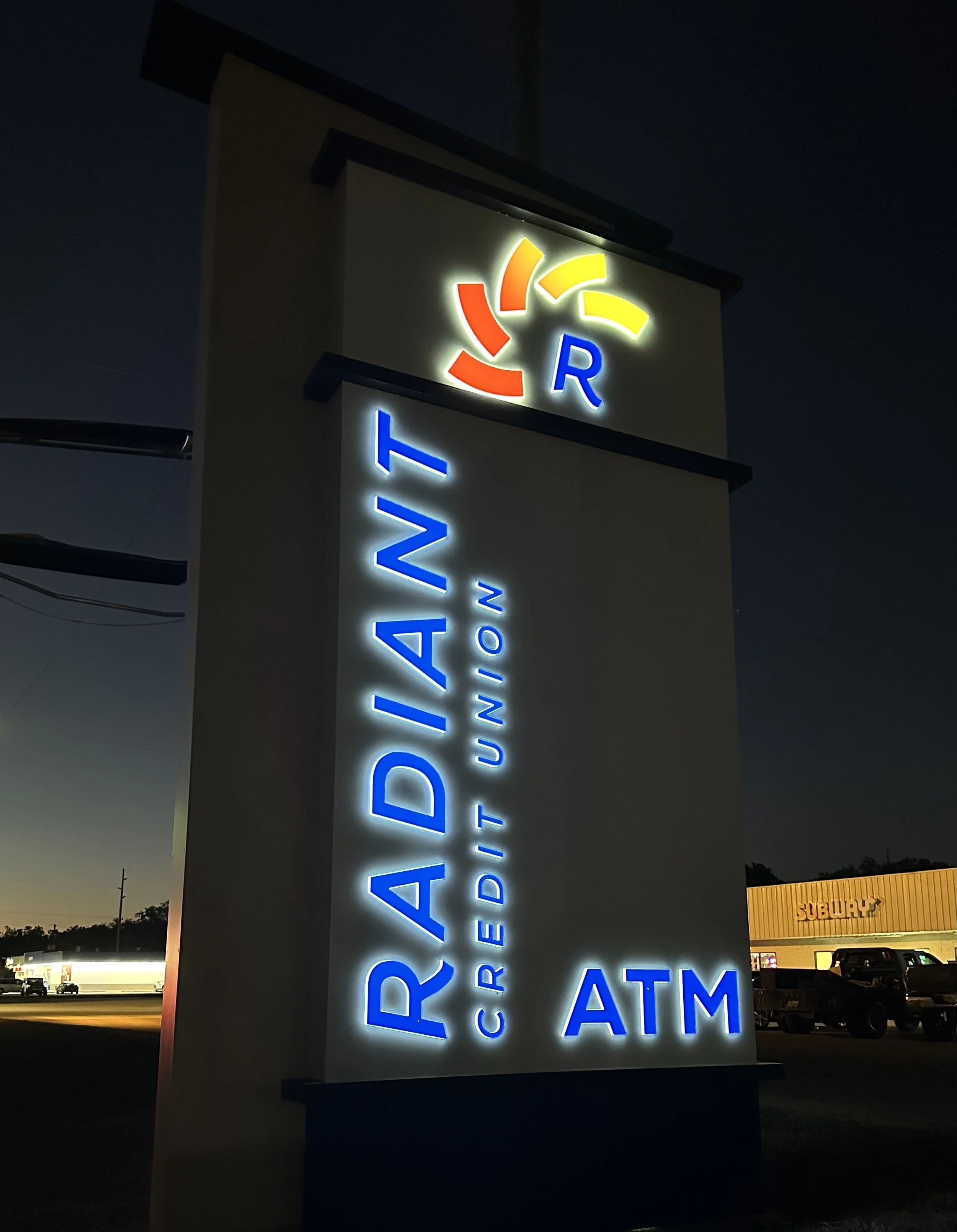 Radiant Credit Union neon sign illuminated at night