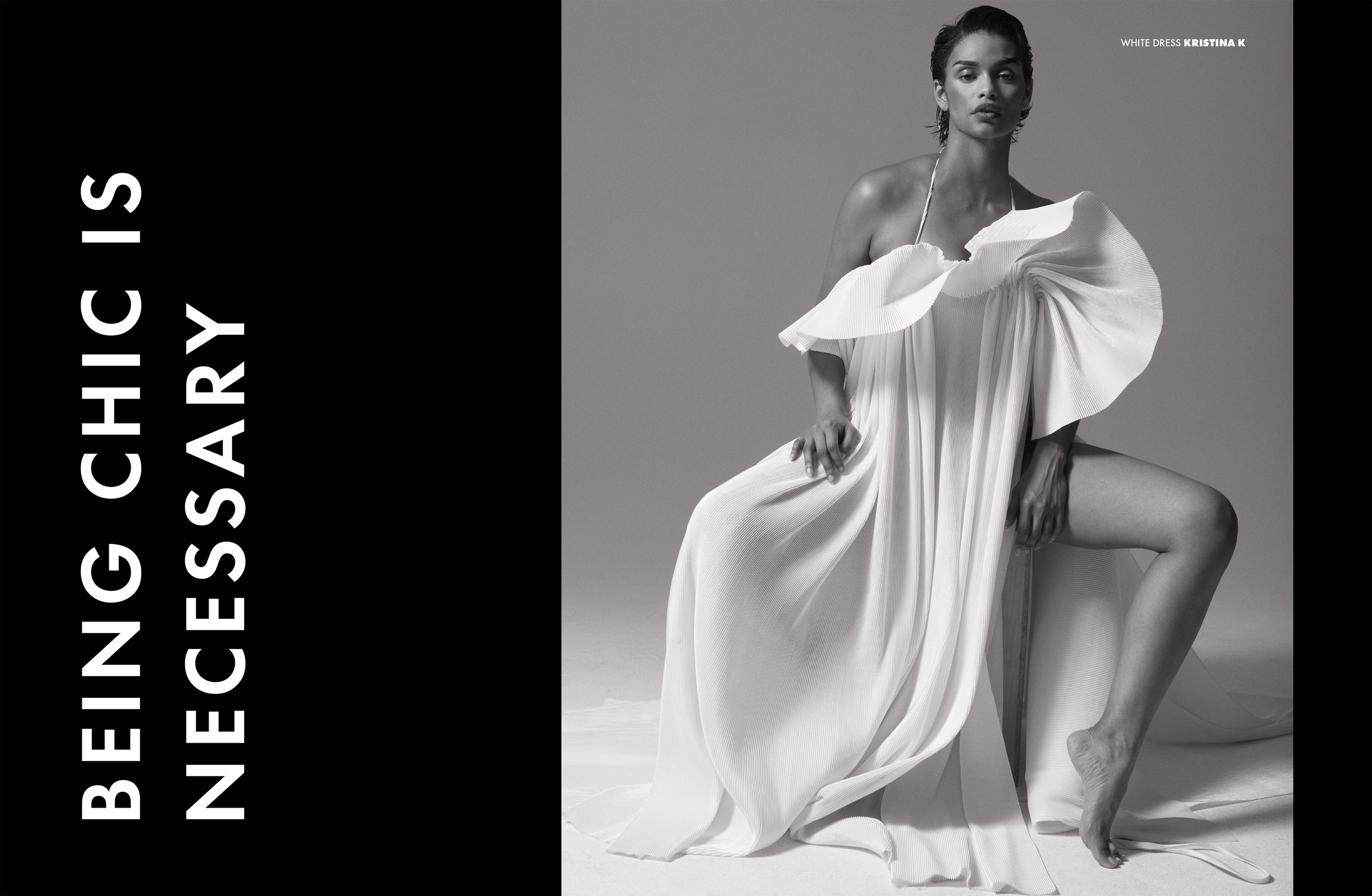 A black-and-white fashion photograph of a woman in a white dress with large, ruffled sleeves, sitting with one leg bent and holding the dress. The text on the left says, "BEING CHIC IS NECESSARY," and the top right indicates the woman is wearing a white dress by Kristina K.