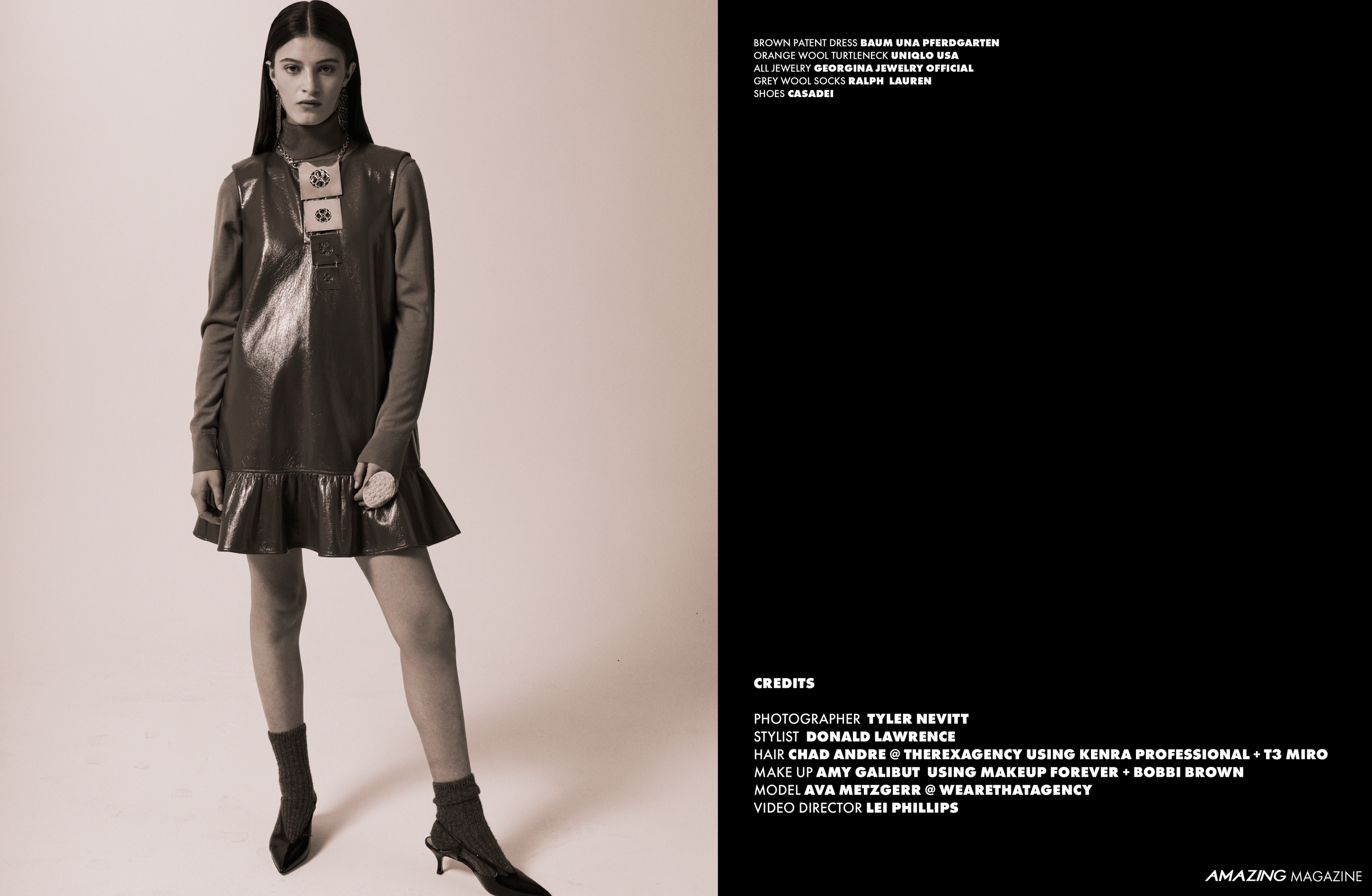 A woman with long dark hair, wearing a shiny brown sleeveless dress with a ruffled hem, gray long-sleeve top underneath, black pointed heels, and dark socks, standing against a plain background.