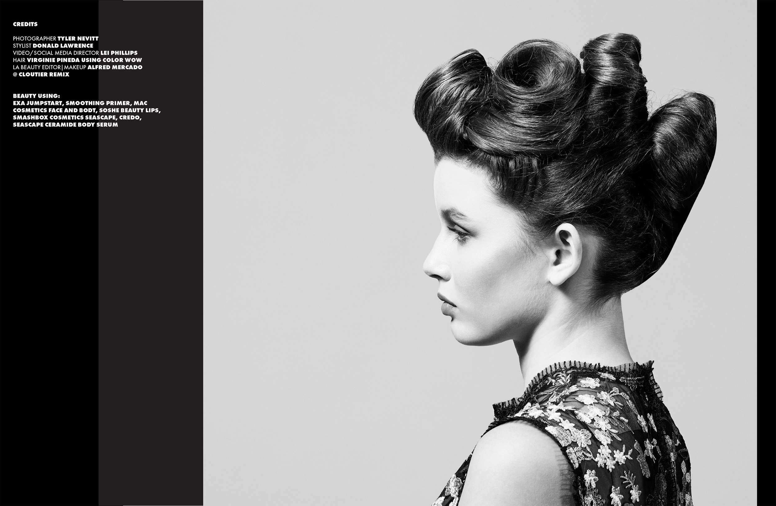 A black and white portrait of a woman with an elegant updo hairstyle, wearing a floral patterned dress, facing sideways.