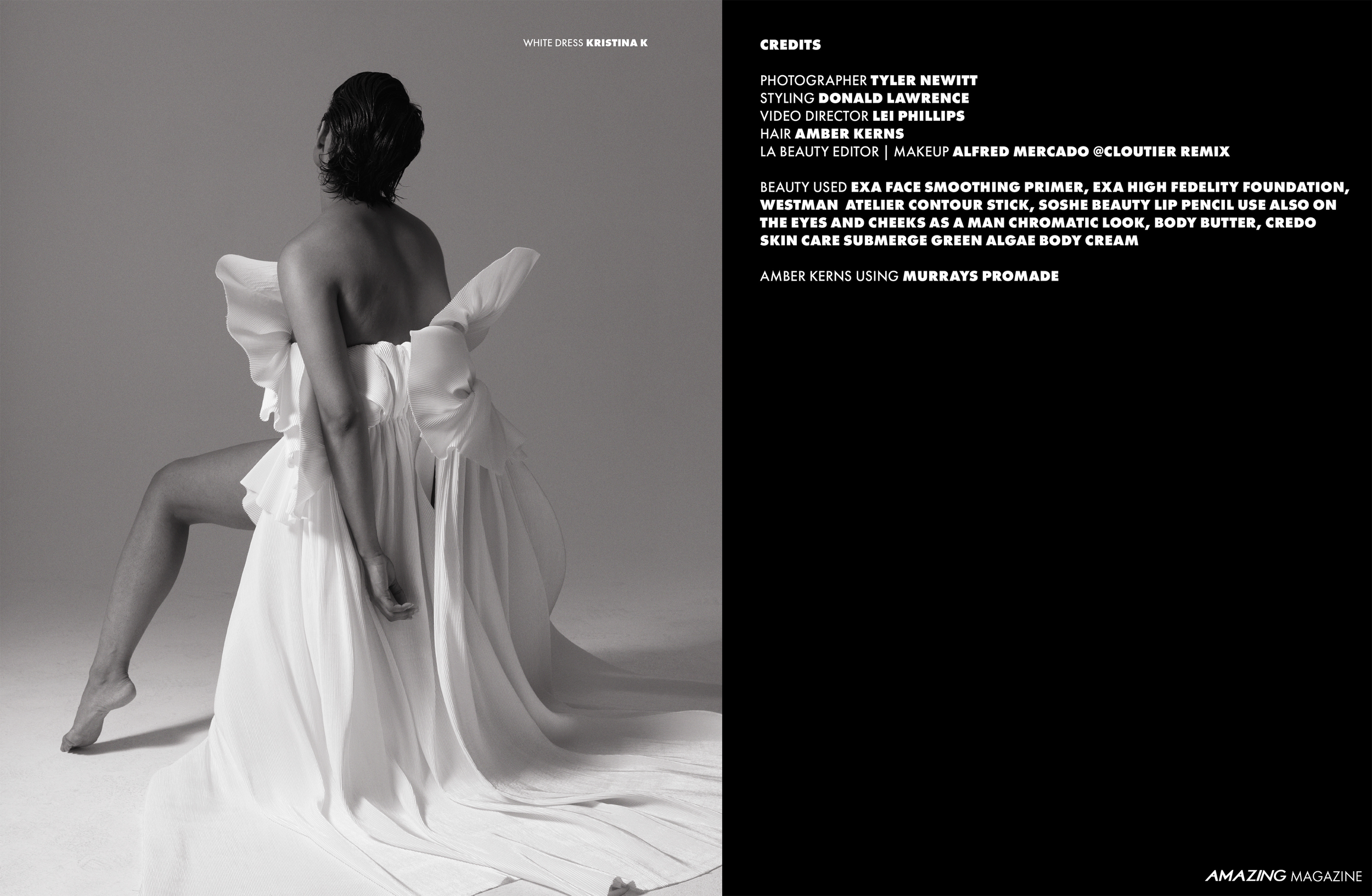 Black and white image of a woman with short hair, kneeling with one knee up, wearing a large, off-the-shoulder white dress with ruffled sleeves and a long, flowing skirt, against a plain background.