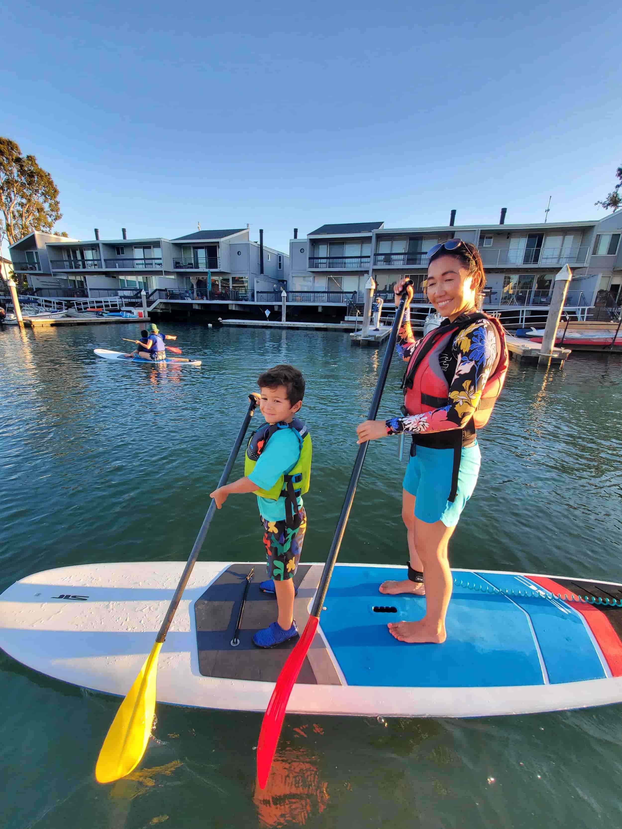 A family on a paddleboard, for Family Paddle Night near Oakland, CA. 