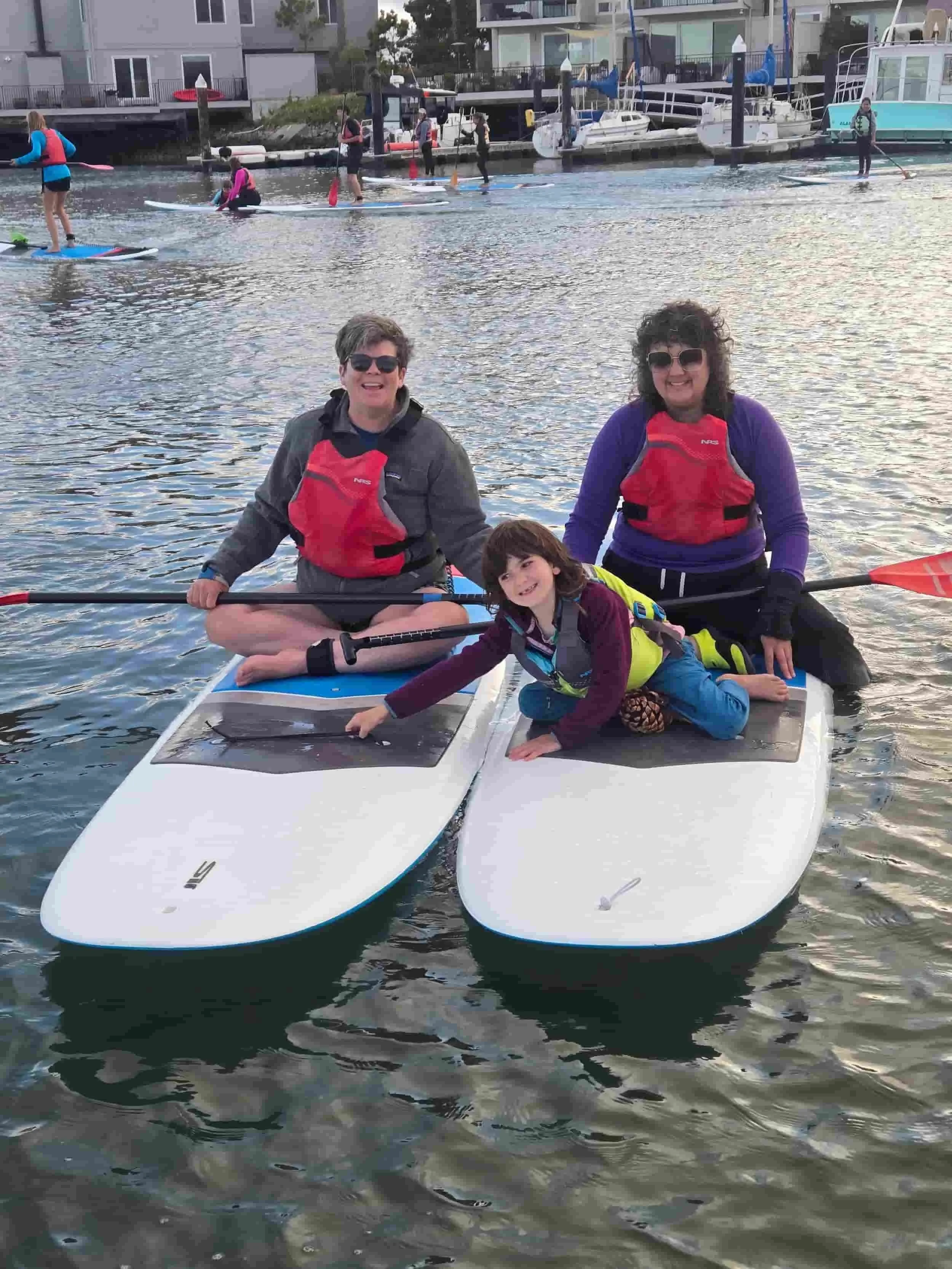 A family paddling in Alameda for Family Paddle Night.