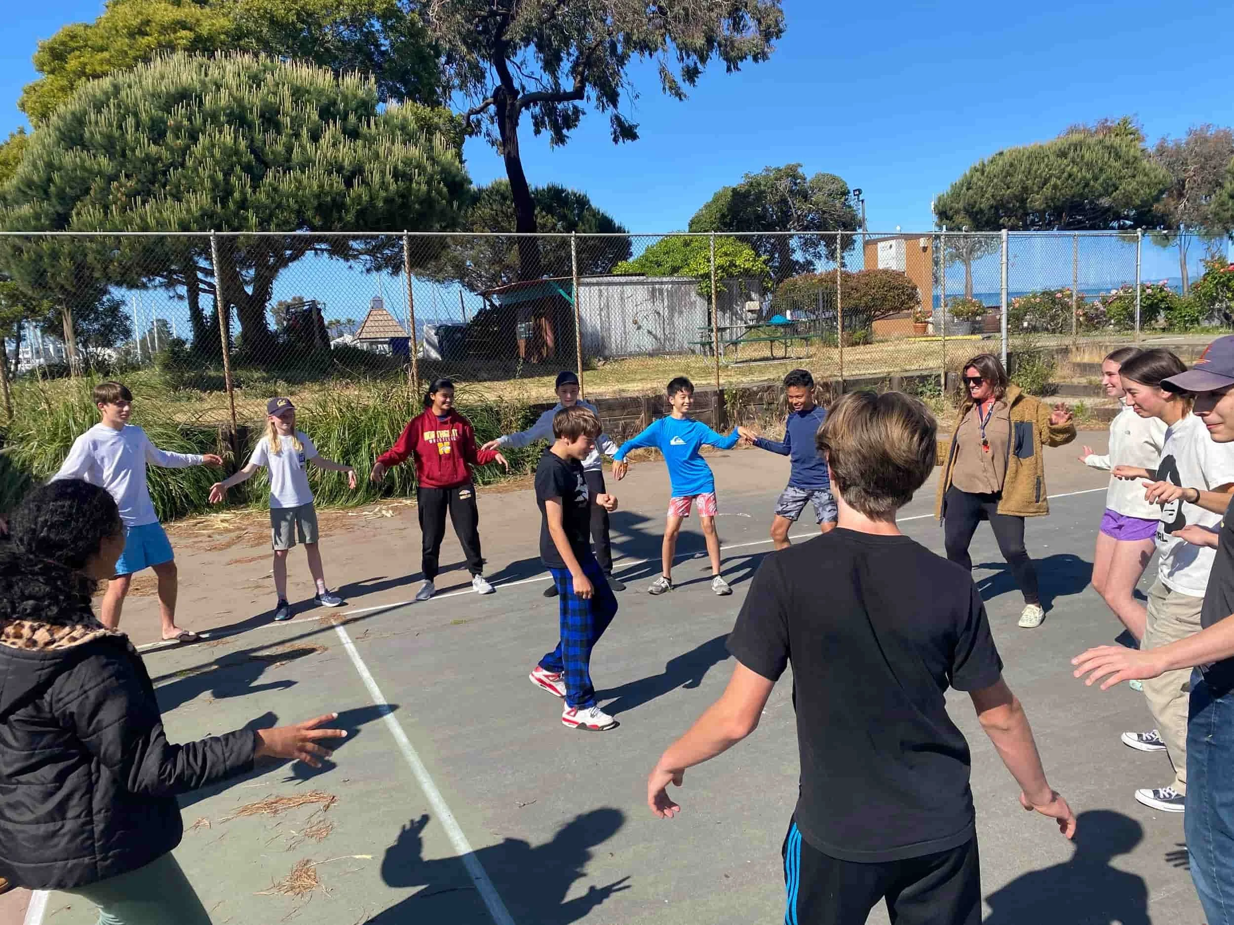 Children playing teambuilding games at summer camp in Alameda.