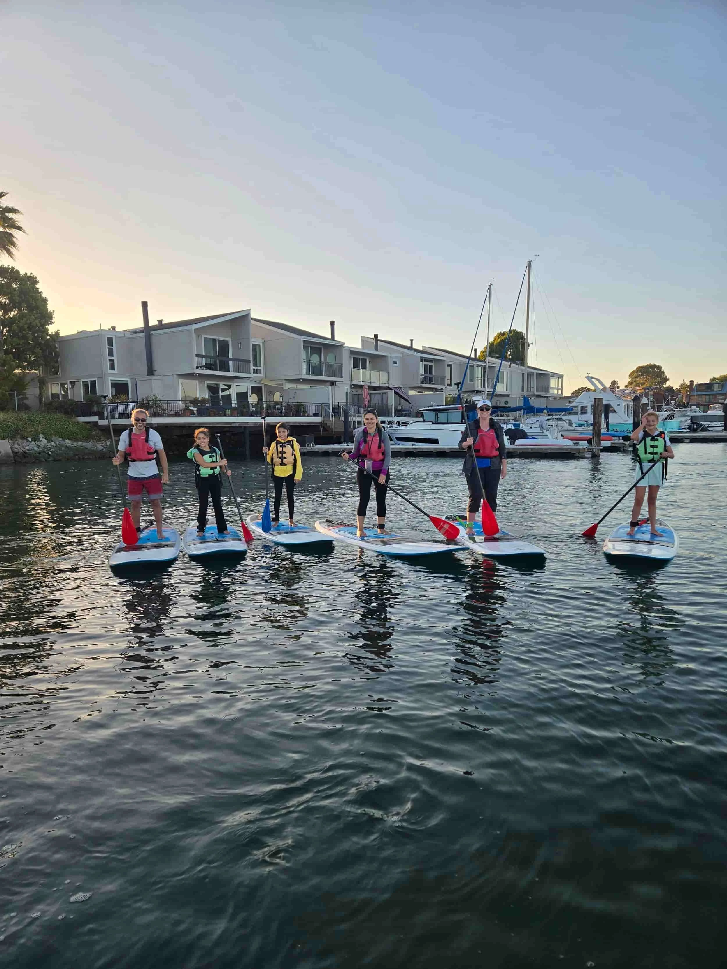 A East Bay family paddling during sunset for Family Paddle Night in Alameda, CA.