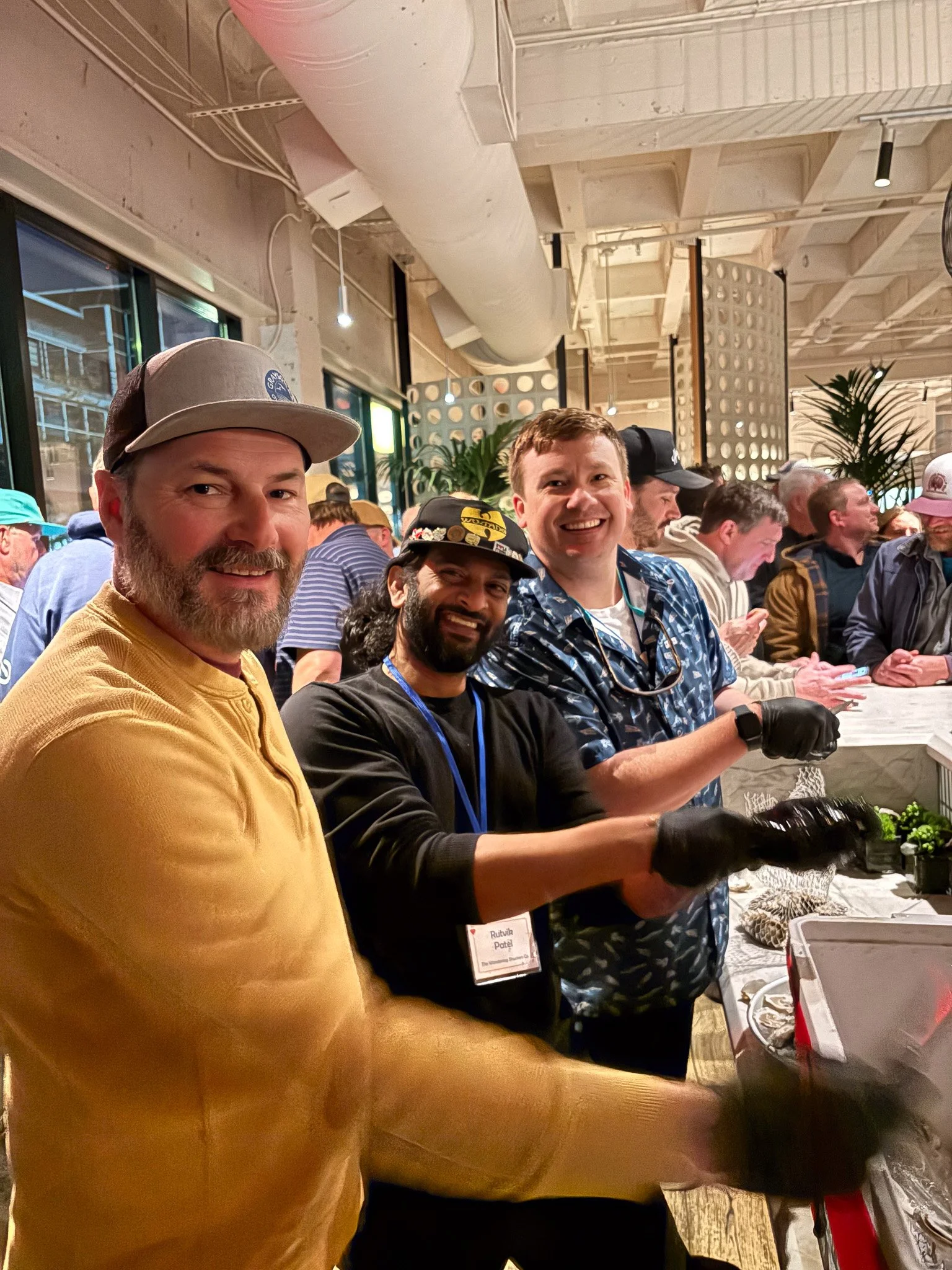 A group of shuckers working at a raw bar station