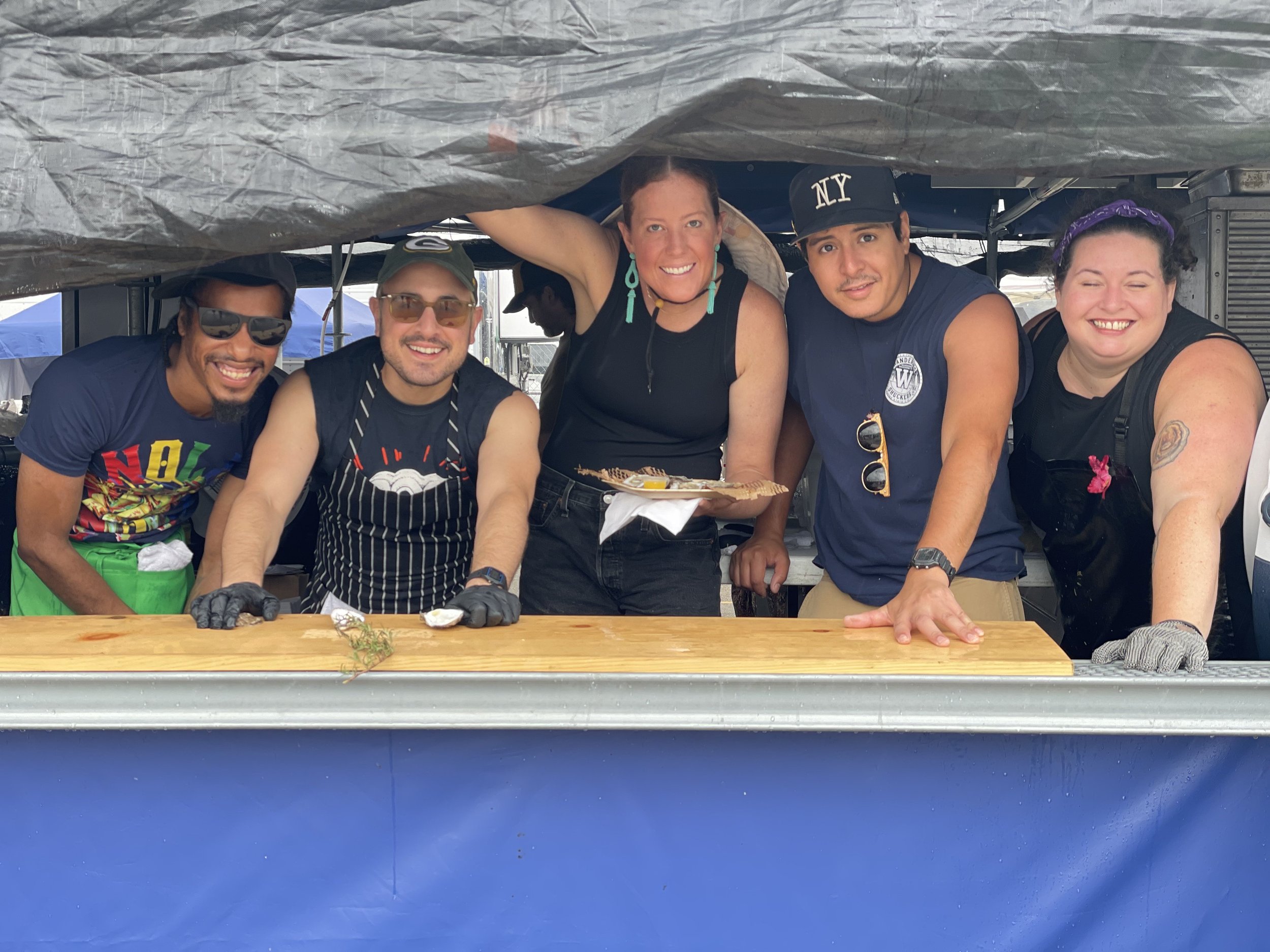 The Wandering Shuckers team at the raw-bar counter at the New Orleans Jazz & Heritage Festival, NOLA 2025