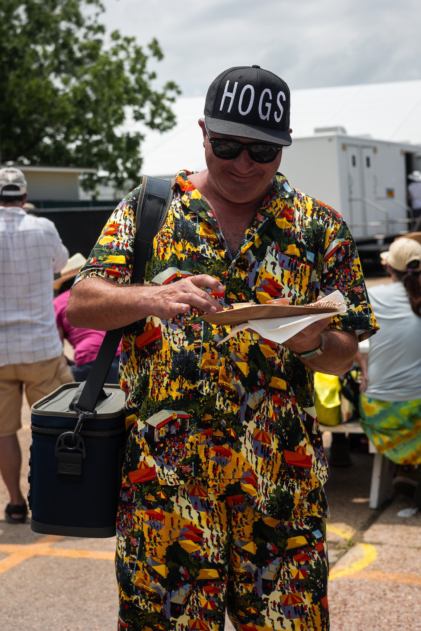 Guest holding a plate of freshly shucked oysters at the New Orleans Jazz & Heritage Festival, NOLA 2025