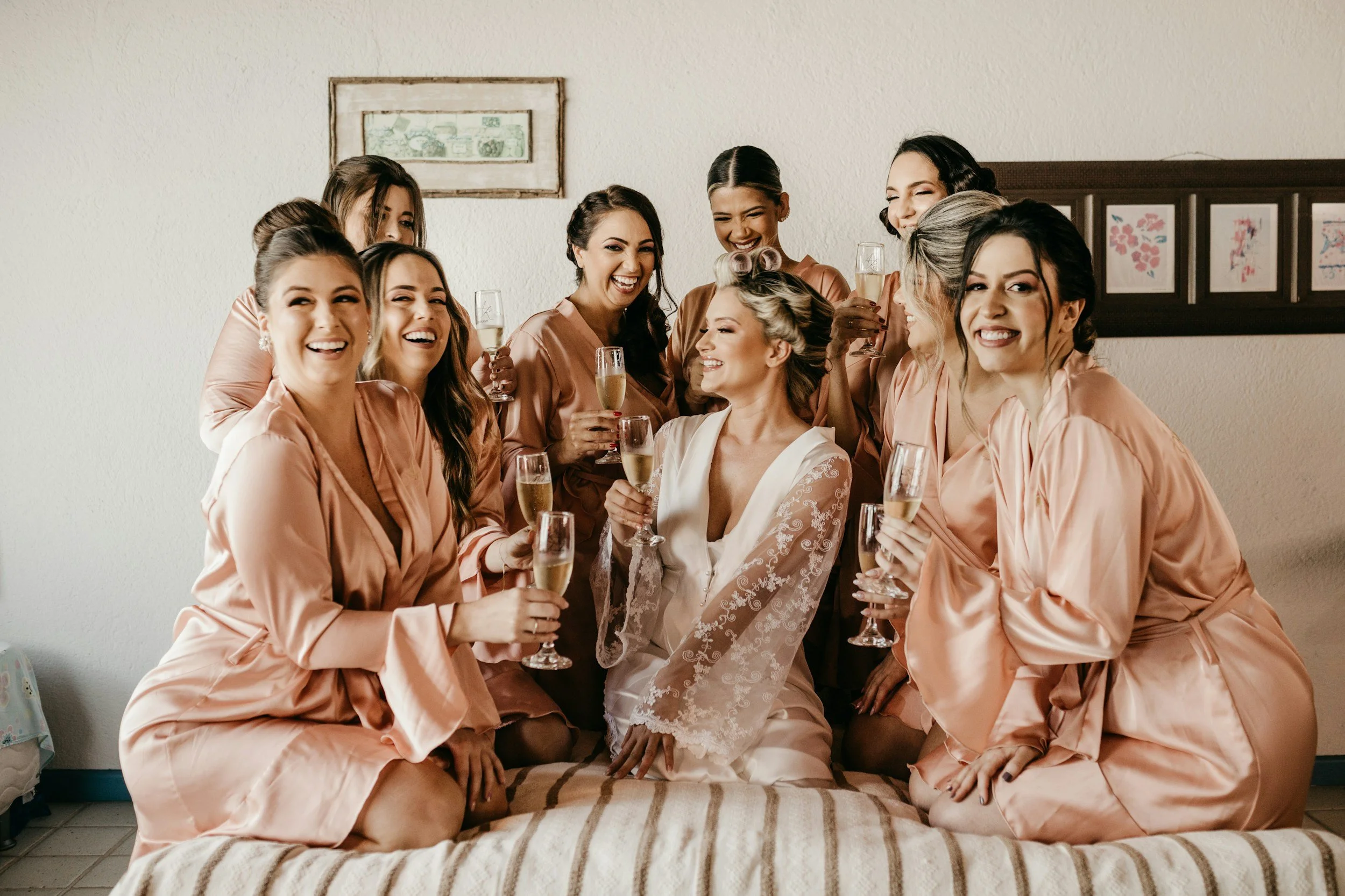 “Women celebrating together in elegant robes before a special event”
