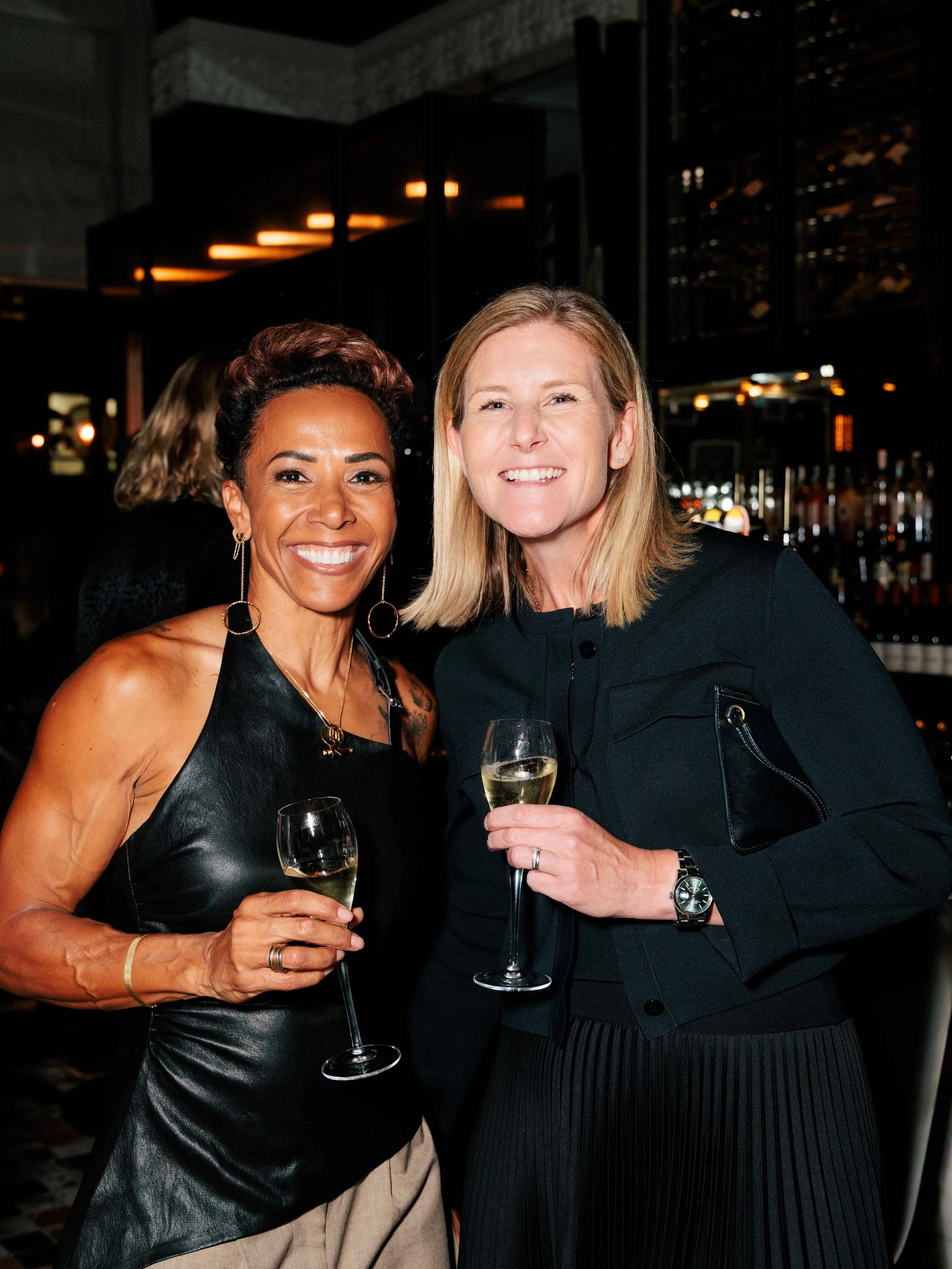 Smiling guests posing for the camera at the Georgie's Bar launch, Corinthia London