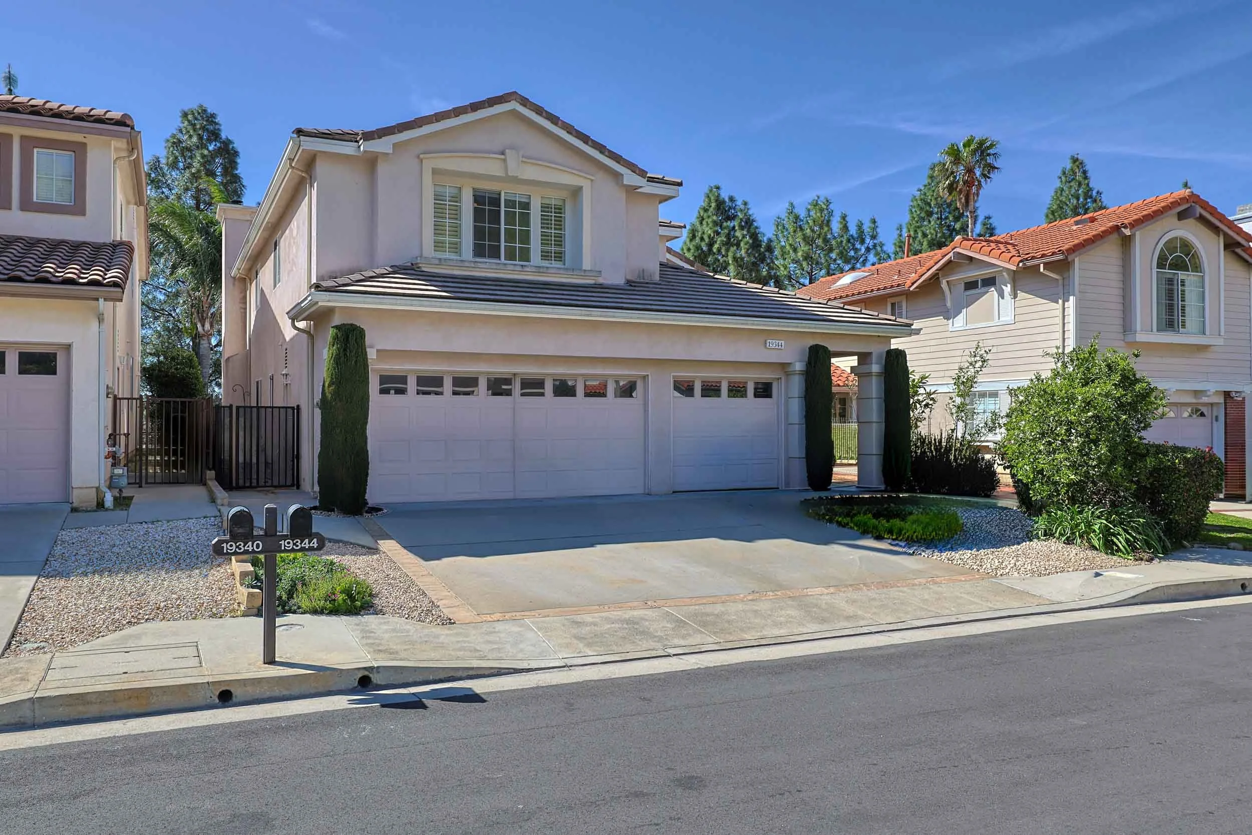Professional real estate photo of single-family home at 19344 Kilfinan Street, Porter Ranch, CA 91326 — backyard spa and mature landscaping in a gated cul-de-sac community.