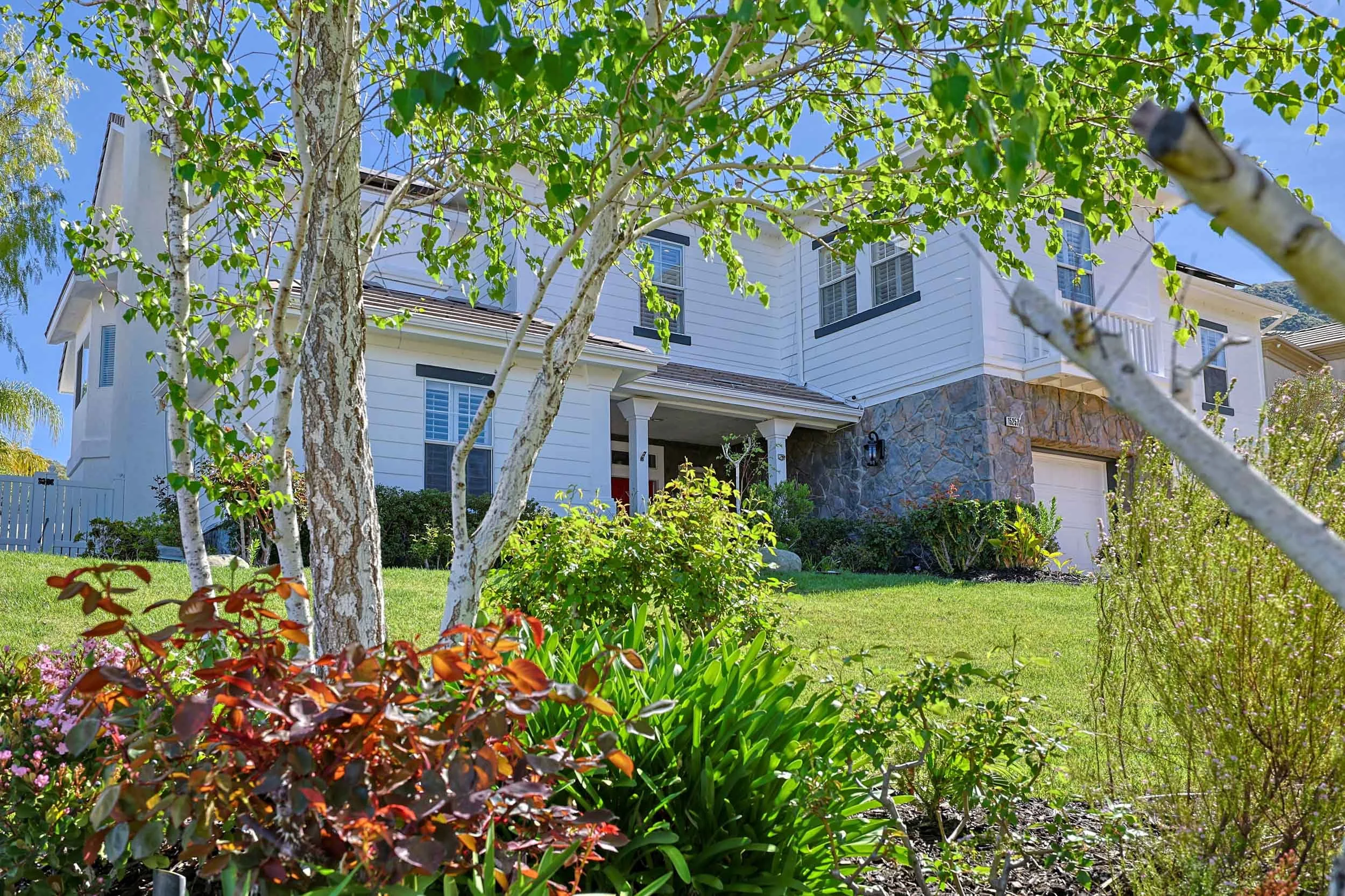Professional real estate photo of single-family home at 15257 Saddleback Road, Canyon Country, CA 91387 — chef's kitchen with quartz countertops and stainless steel appliances.