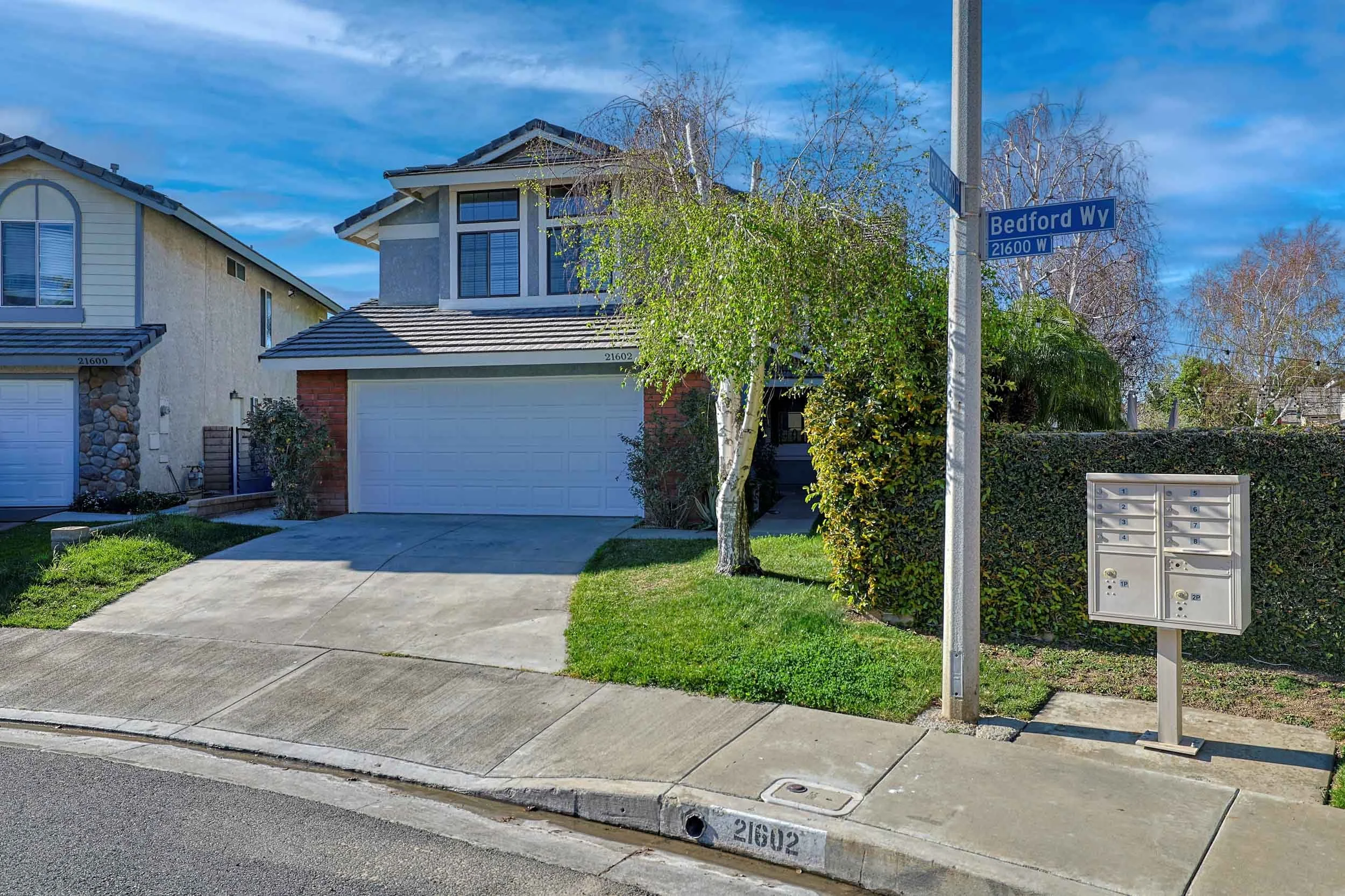 Professional real estate photo of single-family home at 21602 Bedford Way, Santa Clarita, CA 91350 — updated kitchen with granite countertops and stainless steel appliances.