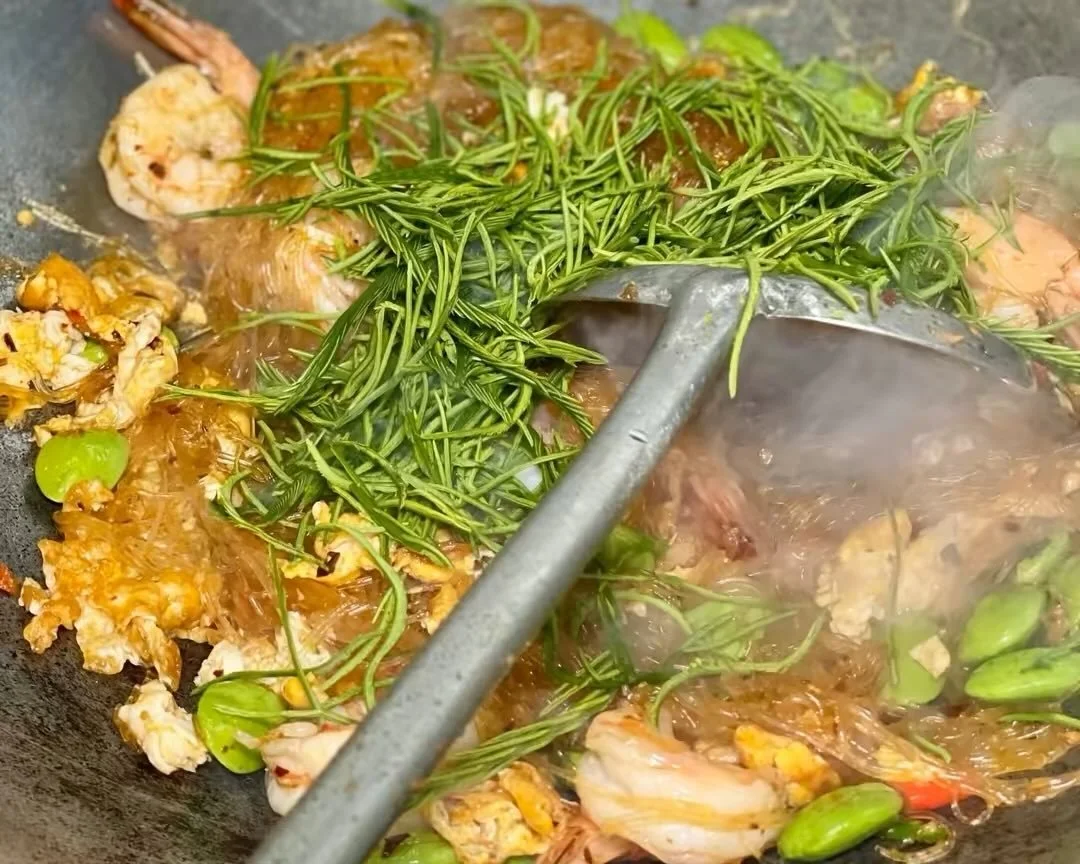 Pad-Some-Men ผัดสามเหม็น
Dare to try? 
Saut&eacute;ed glass noodles Southern Thai style with these 3 guys, Cha-om leaves, Sadtor beans and pickled garlic.