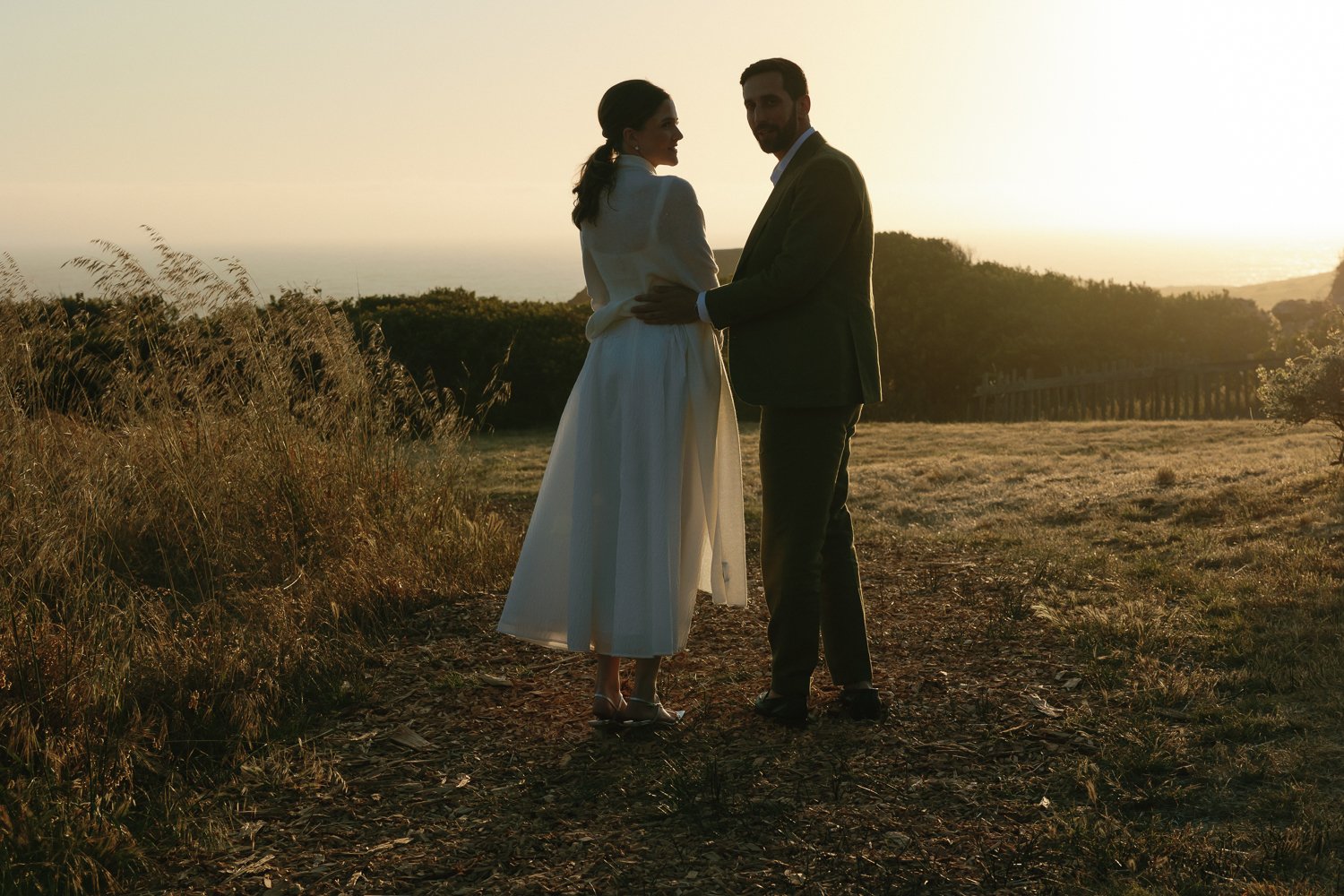 Bride and groom walking through the coastal landscape at The Sea Ranch in Northern California