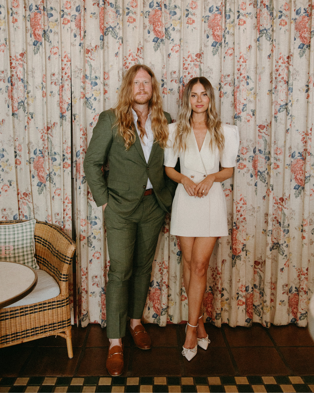A bride and groom at the Palihotel in Santa Barbara in their bar, which features fun vintage curtains.