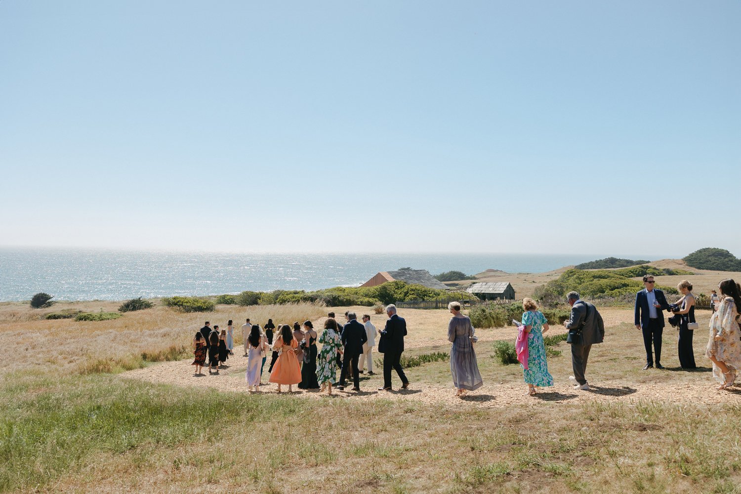 guests walking to a wedding ceremony at the sea ranch lodge
