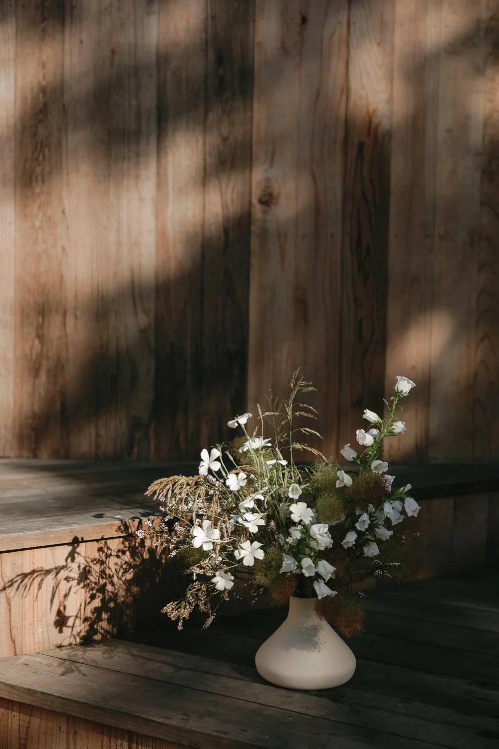 All white floral arrangement with california native grasses