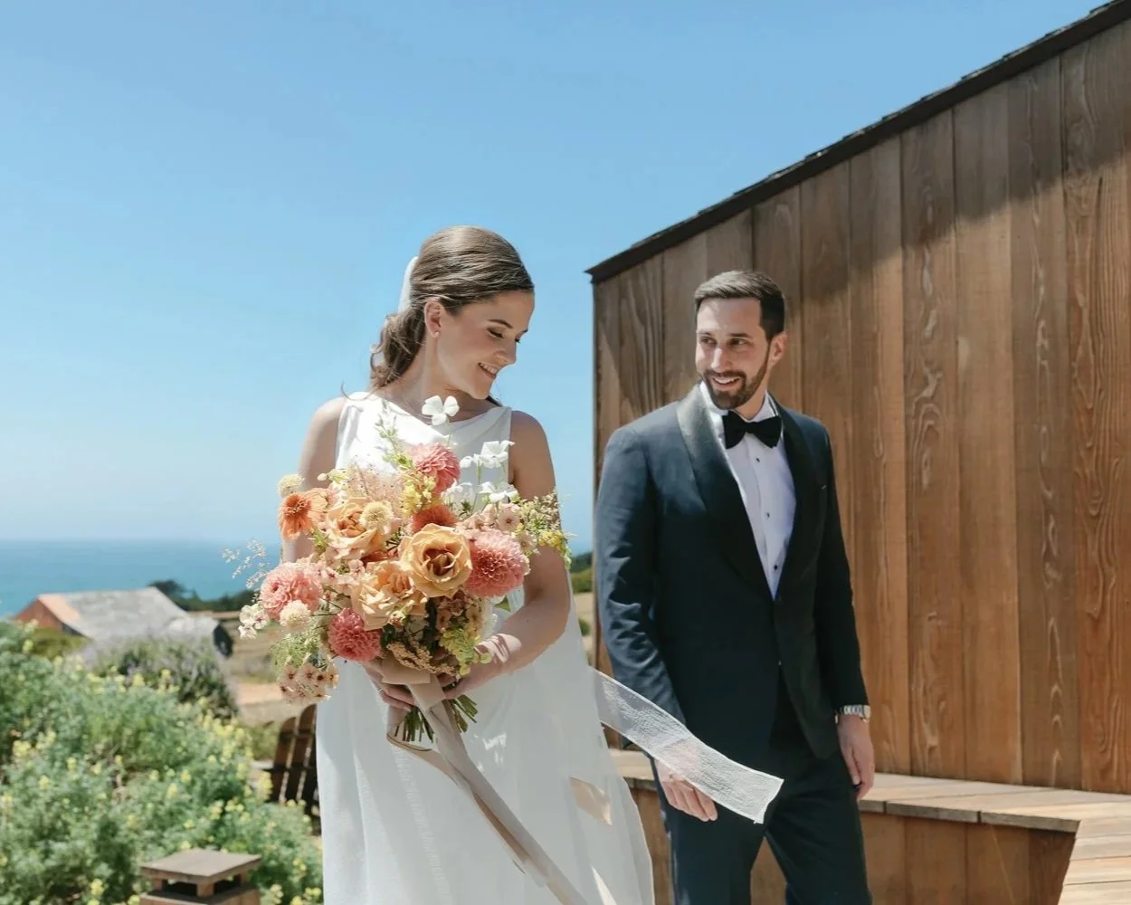 Bride and groom walking through the coastal landscape at The Sea Ranch in Northern California