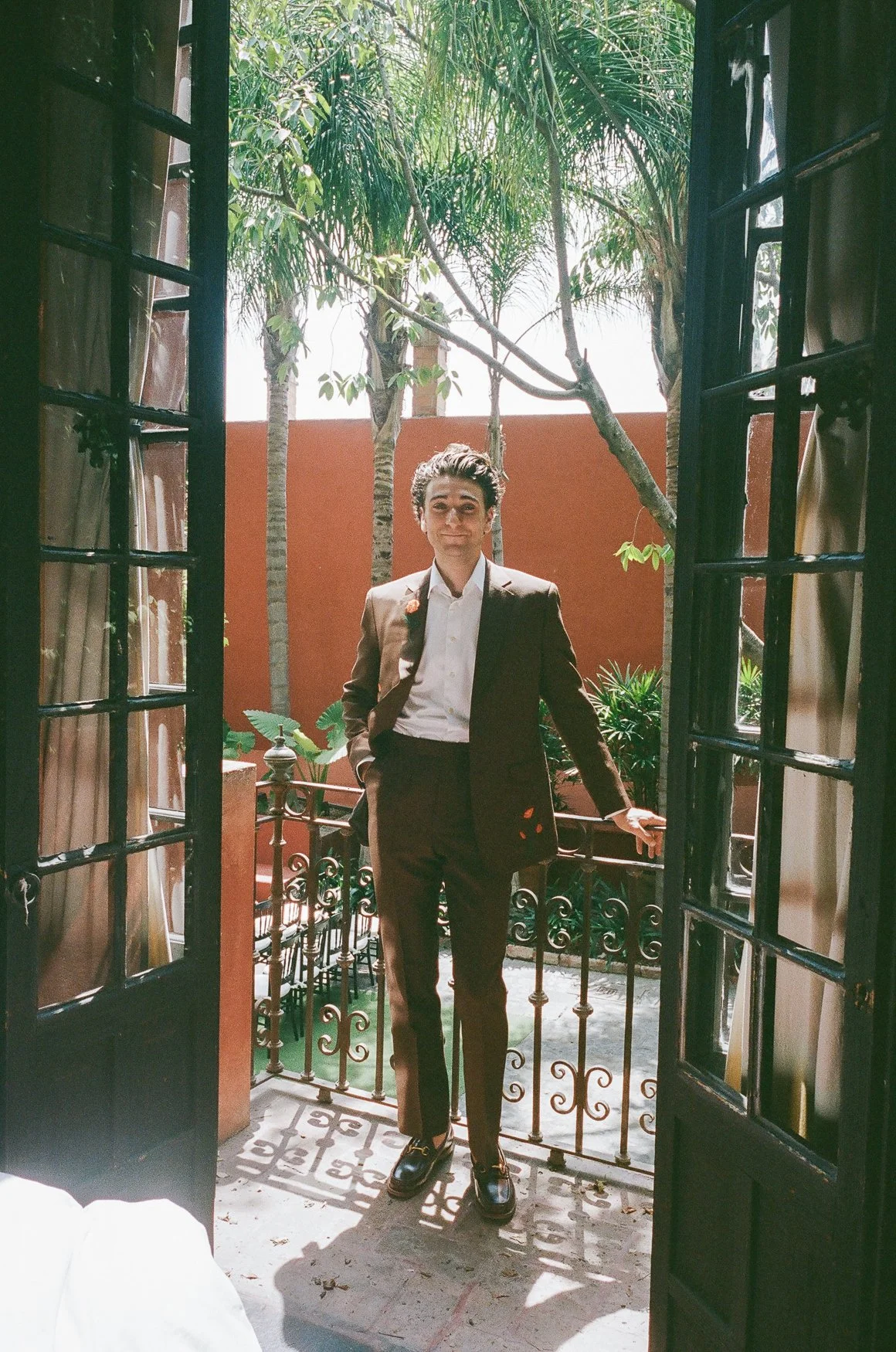 The groom wore a custom chocolate brown suit embroidered with Orange California Poppies