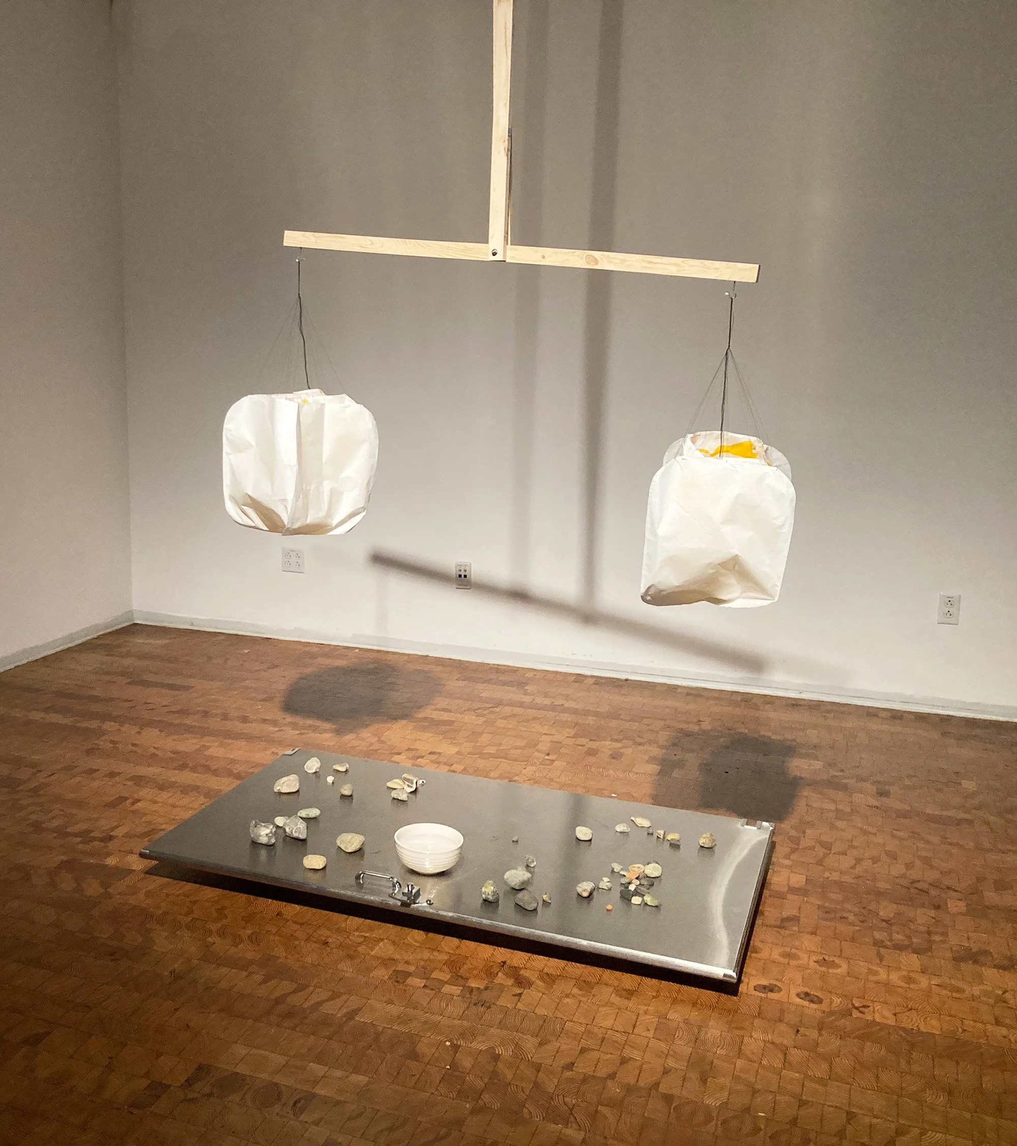 2024; Scale; Wood, stones, bathroom door, rice paper, ink, thread and water installation