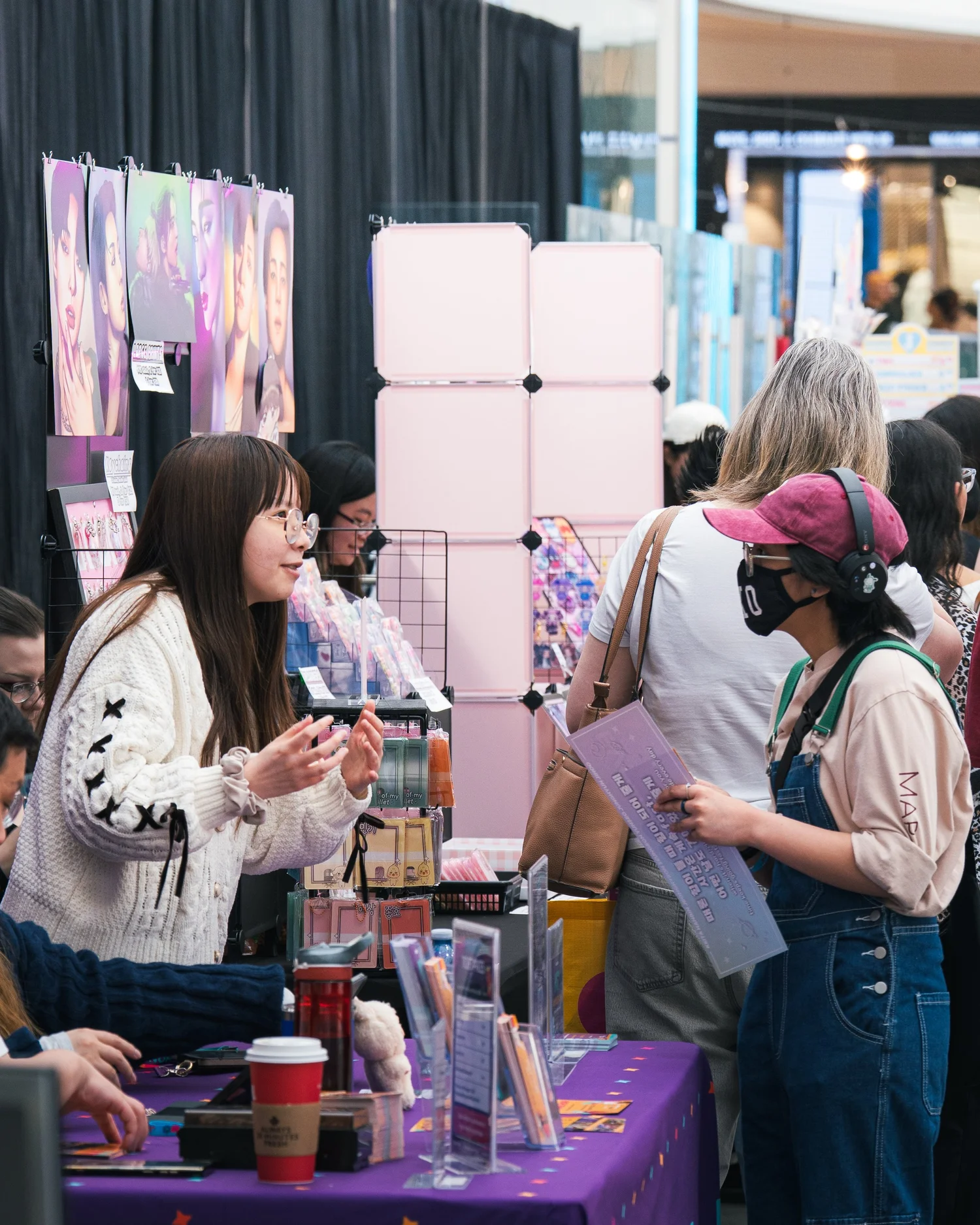 A JAMMY CON vendor booth with attendees shopping at the market