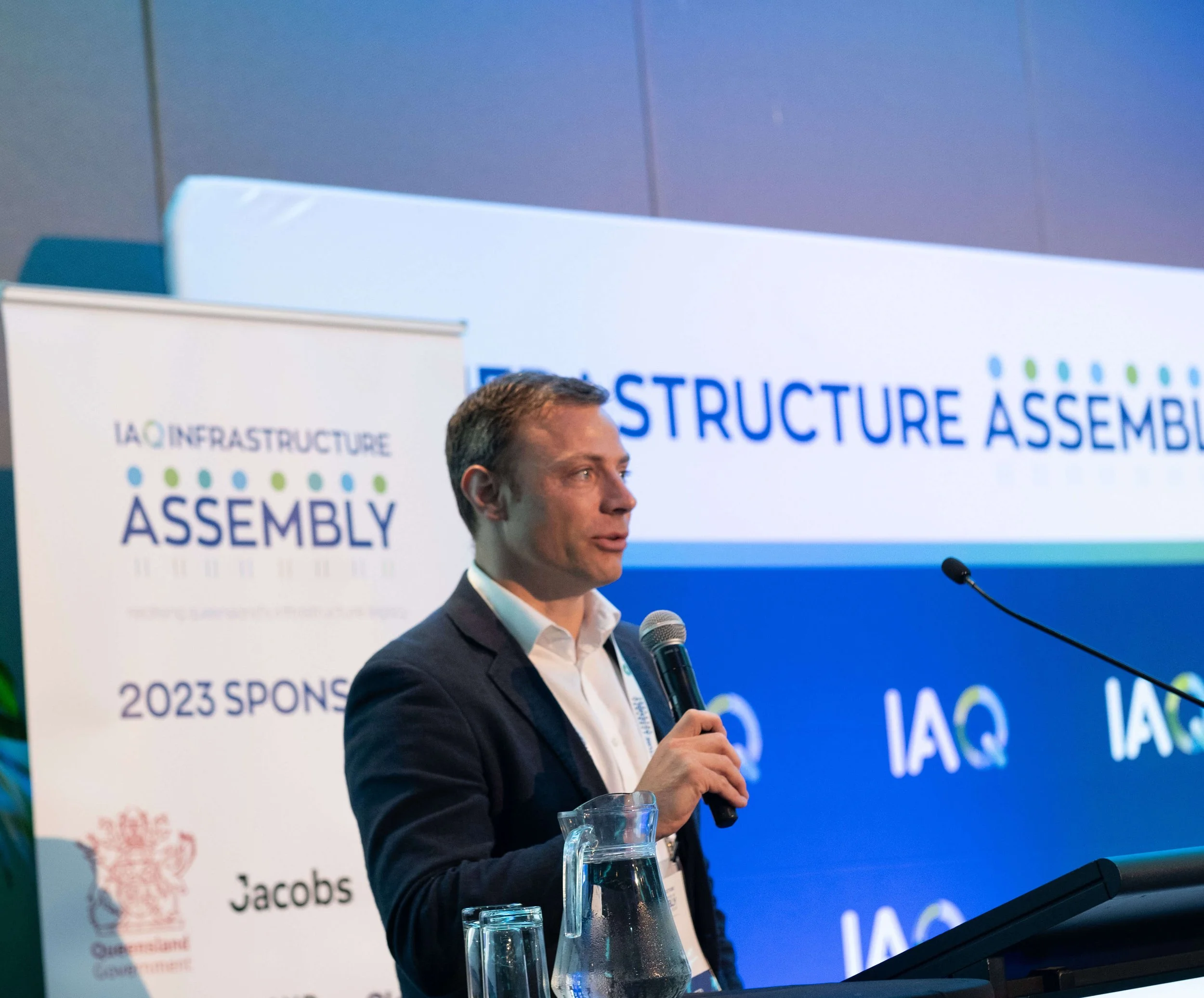 man behind lectun holding microphone