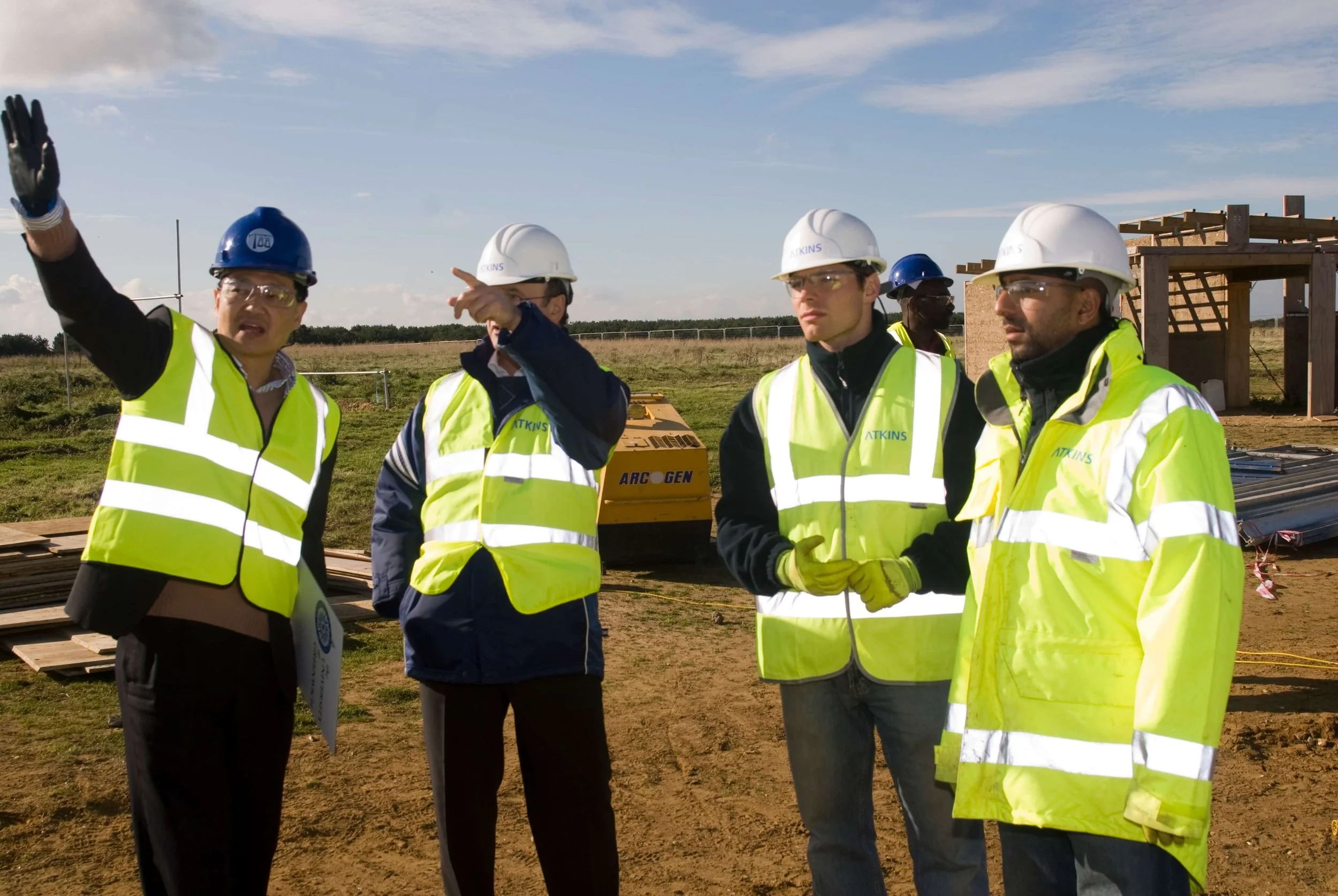 four males in high vis and hard hats