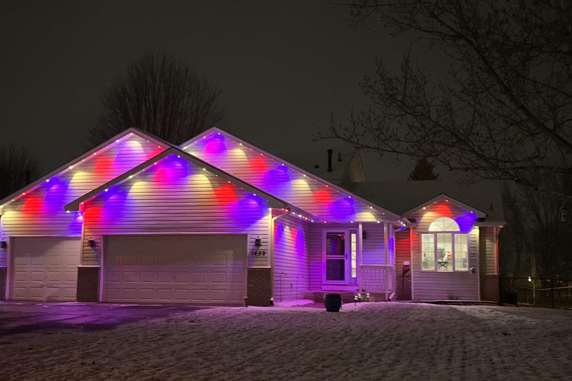 Permanent LED soffit install on a Minneapolis home glowing brilliantly on a clear winter night