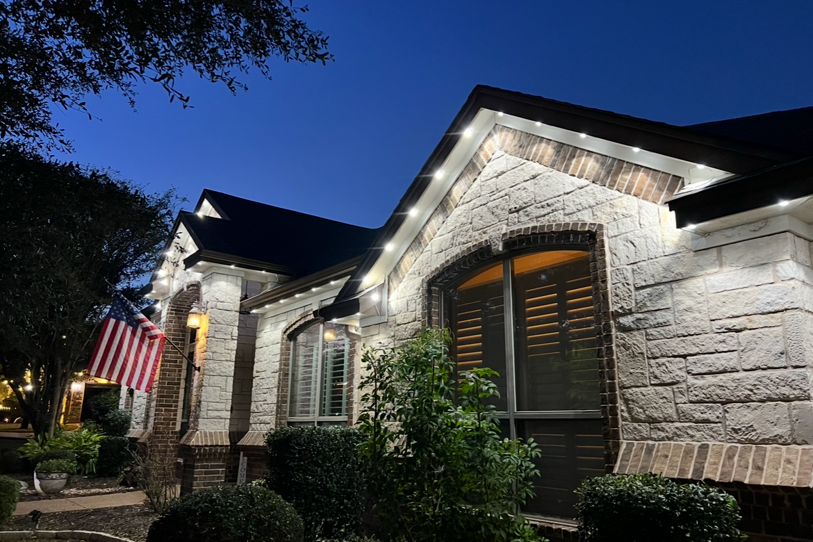 Permanent LED soffit install on a home glowing brilliantly on a clear night