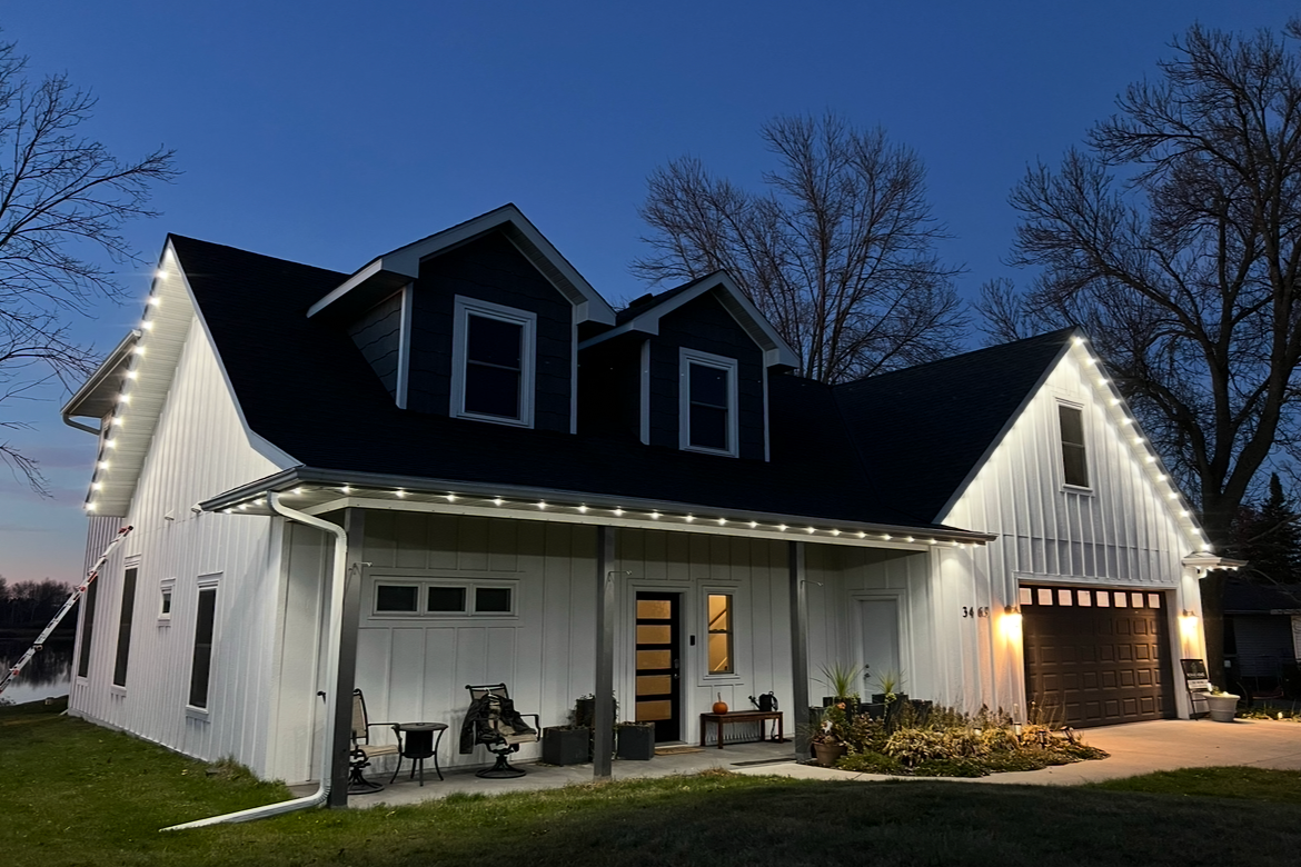 Permanent LED install on a Prior Lake home reflecting beautifully on calm summer night water