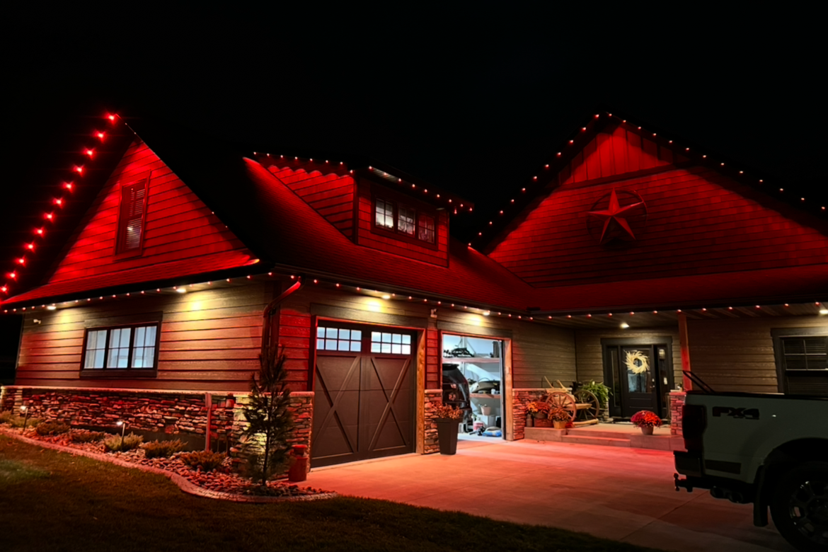 Holiday lighting installation on a Maple Grove two-story home with full roofline coverage