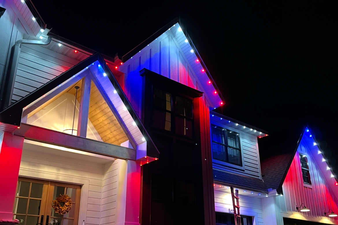 Holiday lighting installation on a Maple Grove two-story home with full roofline coverage