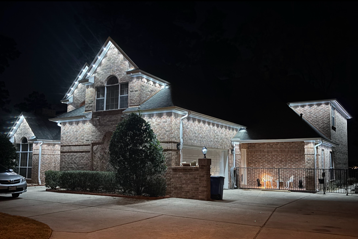 Permanent LED roofline lighting on a Cypress Texas home with full soffit edge installation