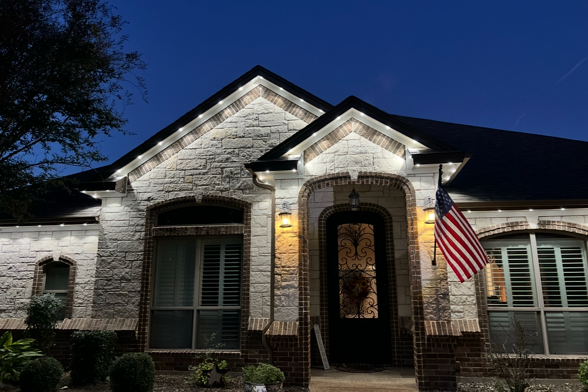 Permanent LED roofline lighting on a Dallas Texas home glowing brilliantly on a clear night