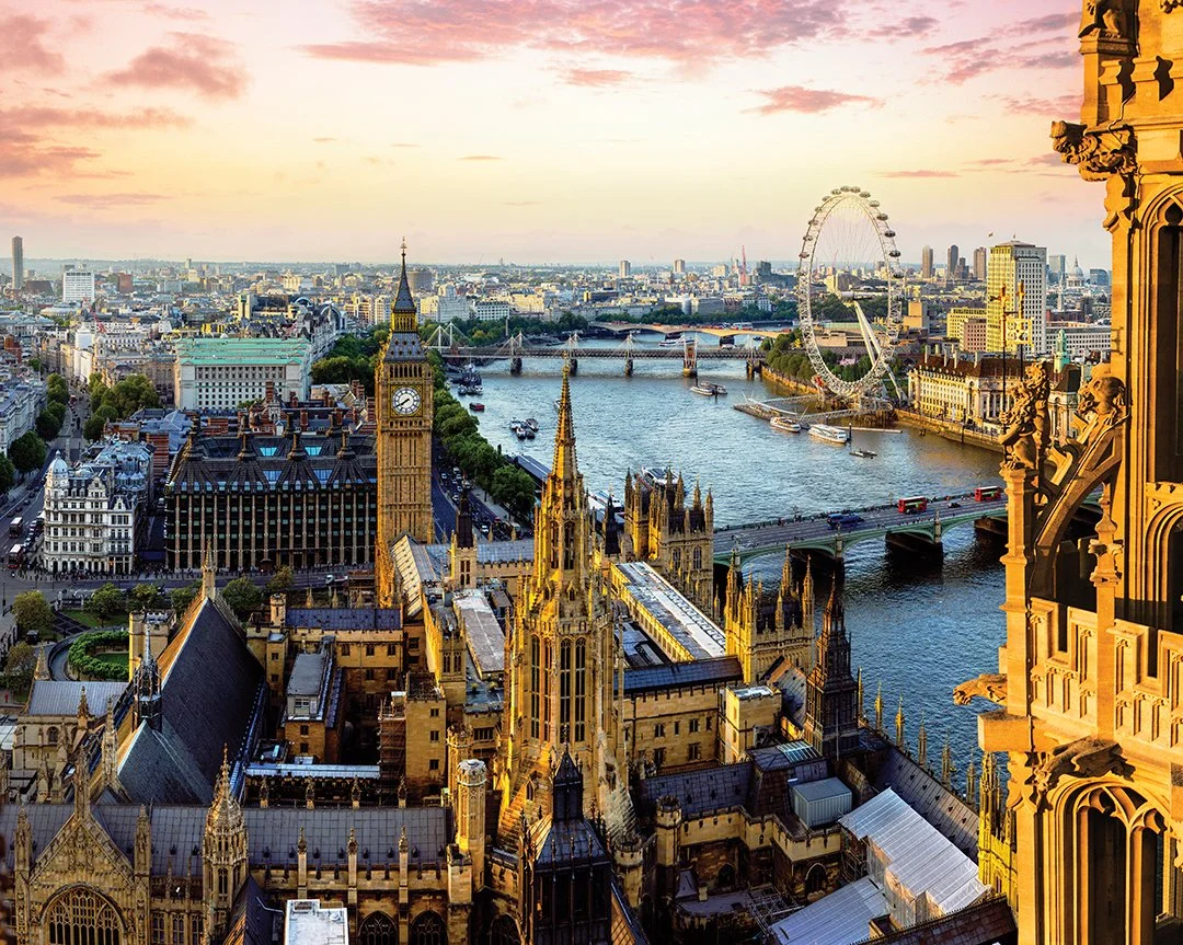 Aerial view of London skyline at sunset, showing Big Ben, the London Eye, River Thames with boats, and historic and modern buildings. Learning Expedition