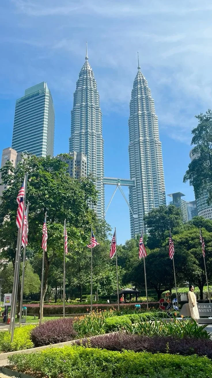 Stock exchange trading floor with multiple large digital monitors displaying colorful graphs and data, people in business attire walking and discussing.