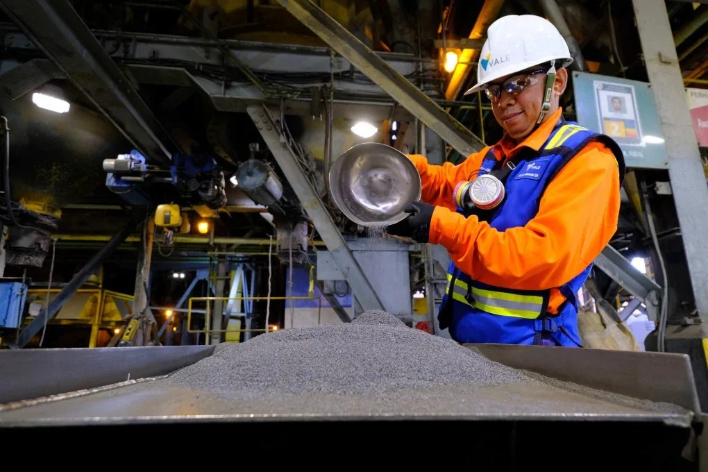 A PT Vale Indonesia worker inspects processed nickel ore at a mining and smelting facility in Sulawesi, Indonesia
