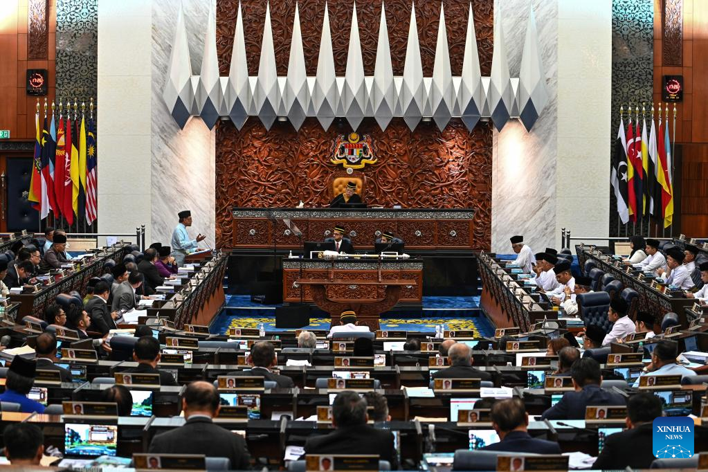 A man taking a selfie with a humanoid robot at a technology exhibition.