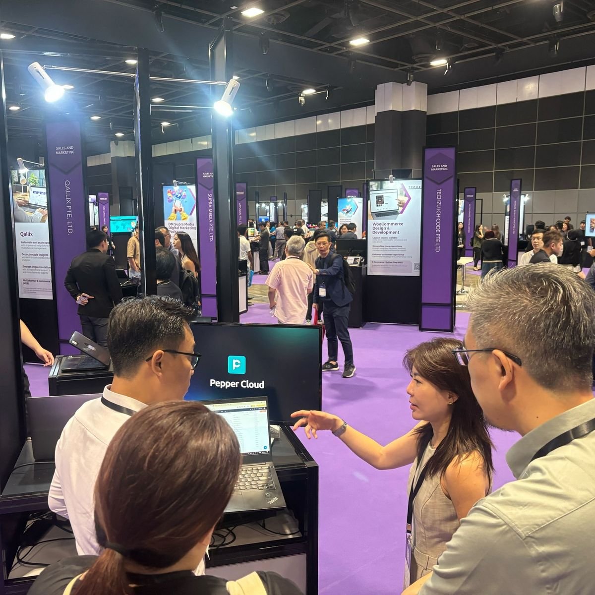 Aerial view of Hong Kong with high-rise buildings, green hills, and Victoria Harbour, including islands and ships in the water under a partly cloudy sky.