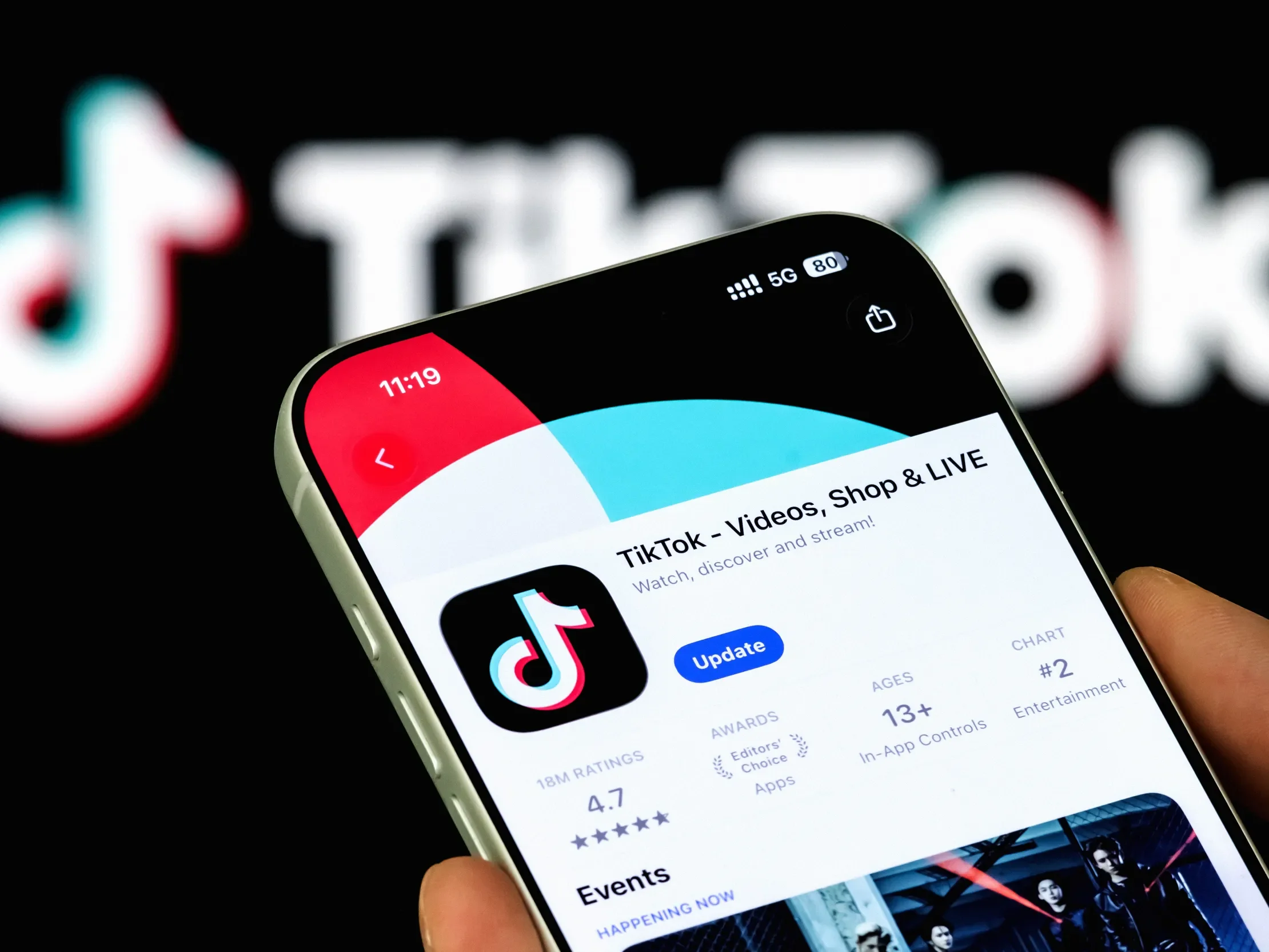 A smartphone displays the TikTok app on the App Store in front of the TikTok logo, illustrating ByteDance's short-form video platform