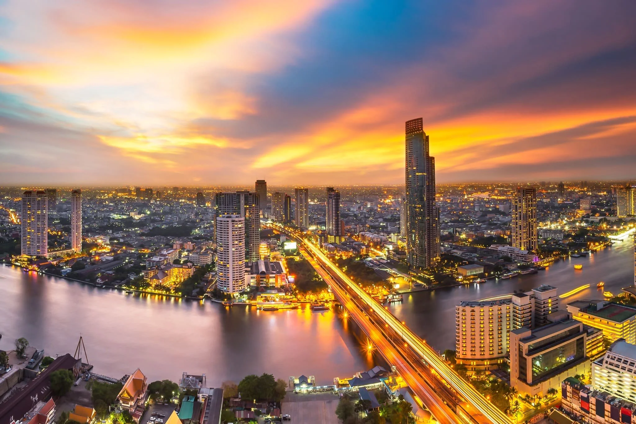 Bangkok skyline and river at sunset, showing Thailand’s business district and growing content economy