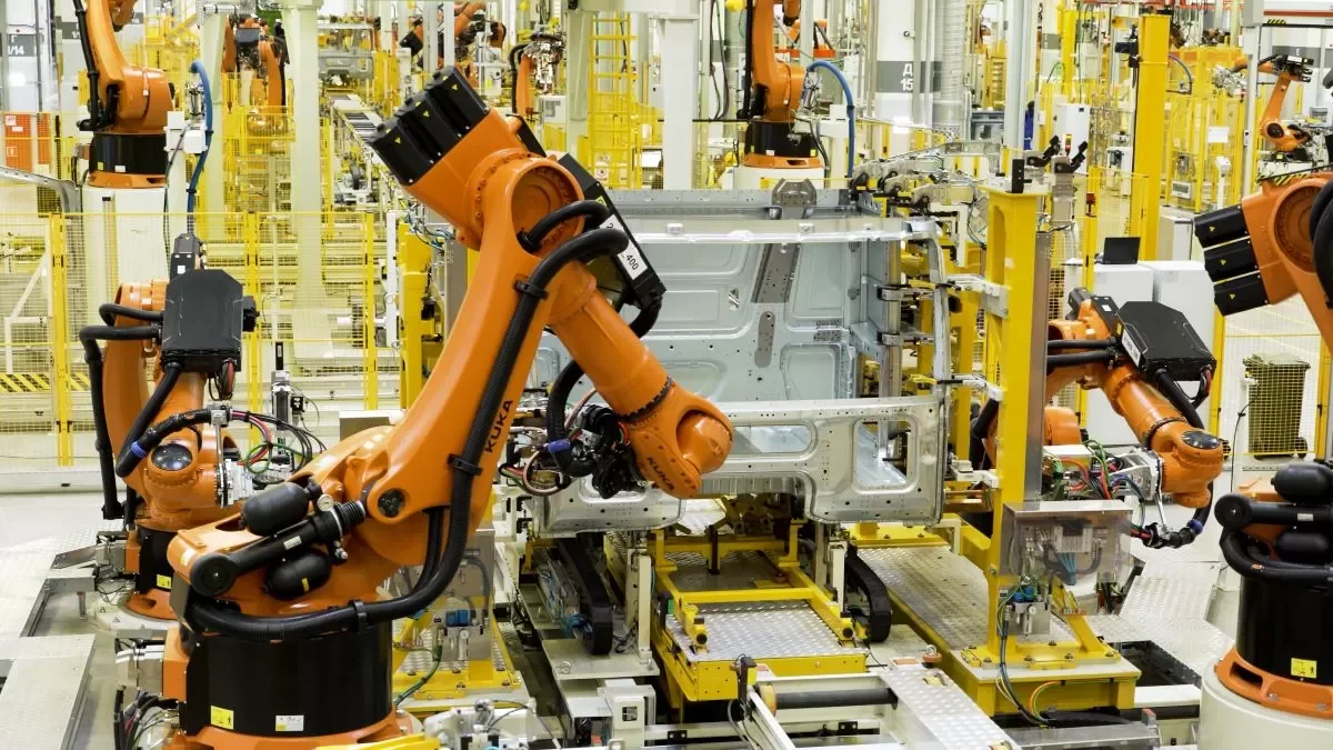 Industrial robots assembling vehicle components on an automated production line, illustrating Asia's leadership in advanced manufacturing and automation.