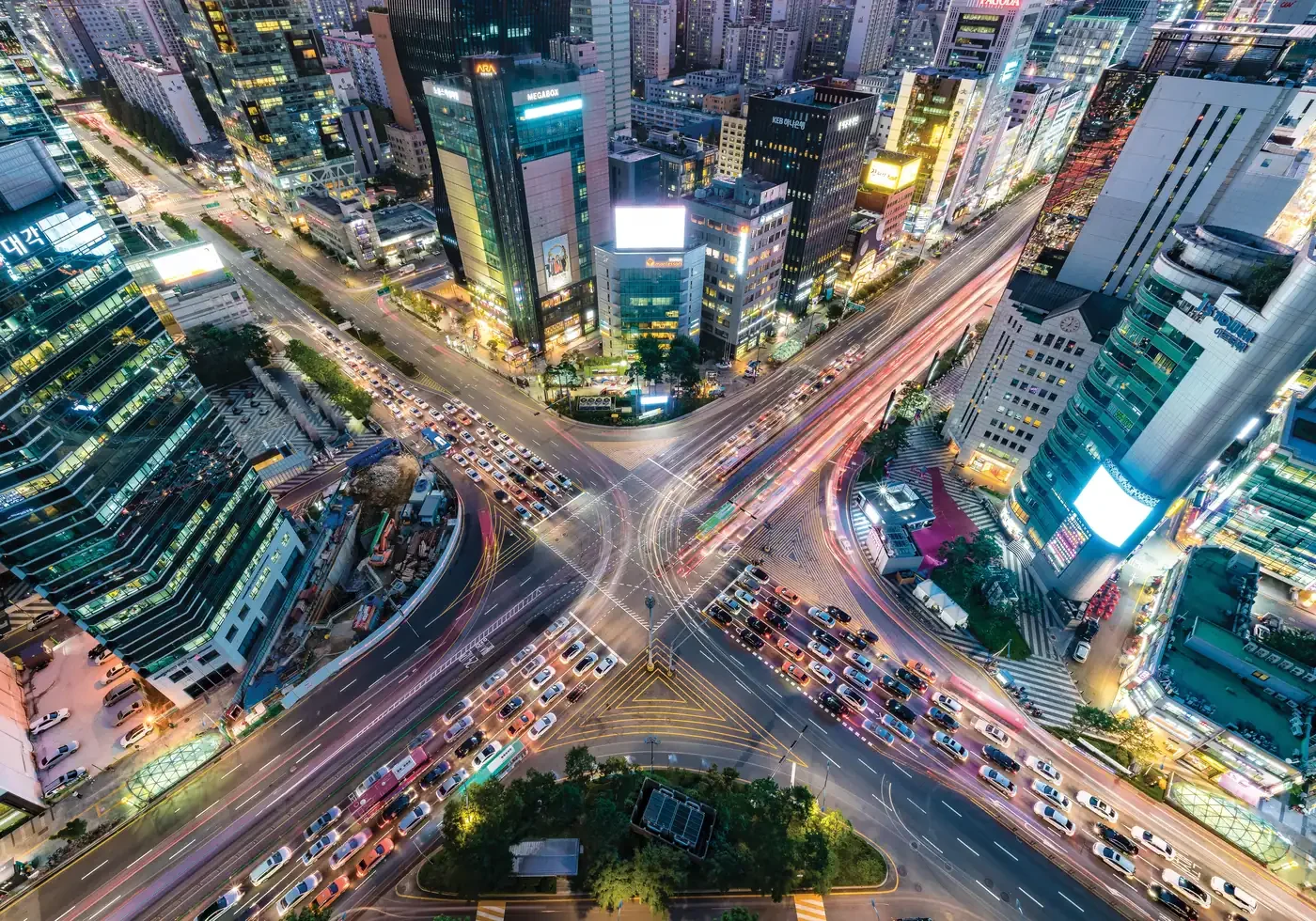 Aerial view of a busy multi-road intersection in Seoul at night, illustrating the fragmented customer journey