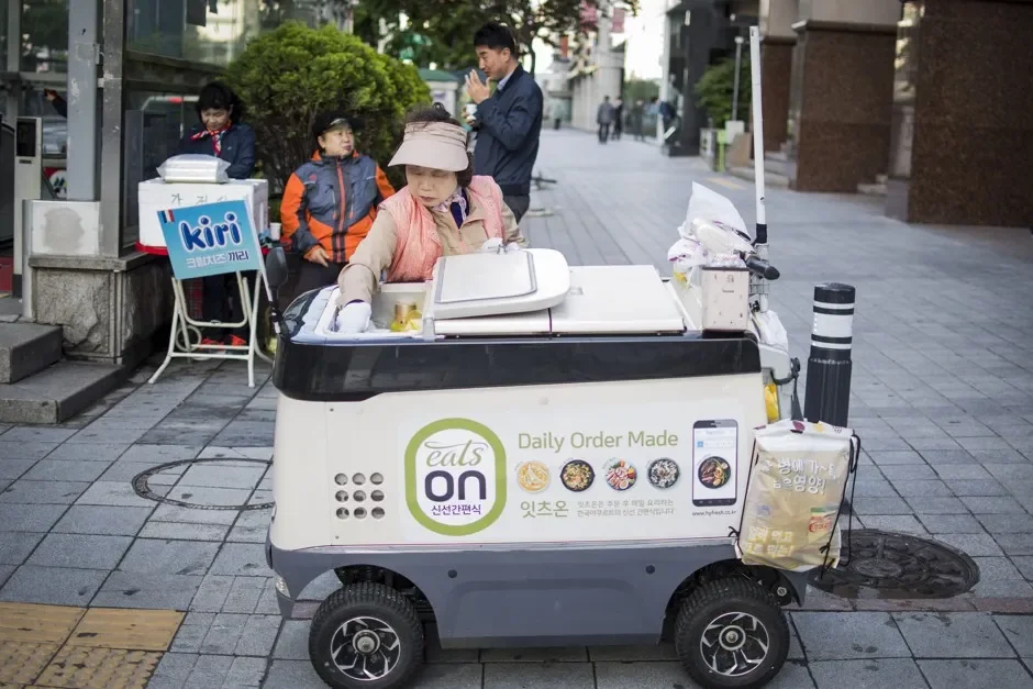 A "yogurt ajumma" sells cold drinks from her motorized refrigerator cart on a street in Seoul, South Korea