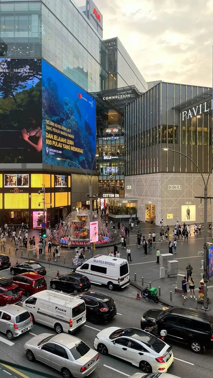 Panel discussion with six people on stage at a conference in Milan, held on November 27, 2025, with a large blue screen and banners displaying event details and logos in the background.