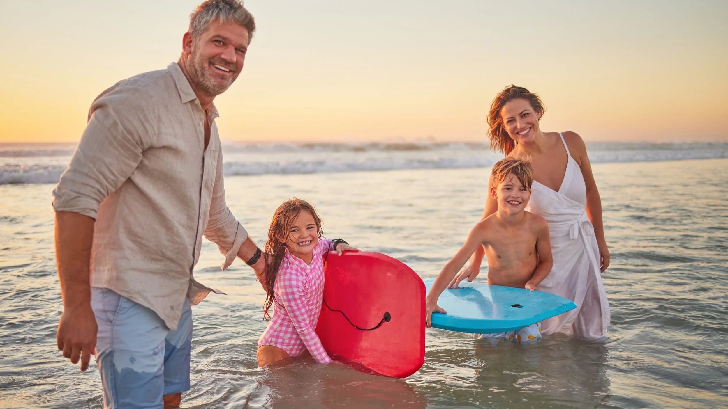 Family playing in the surf