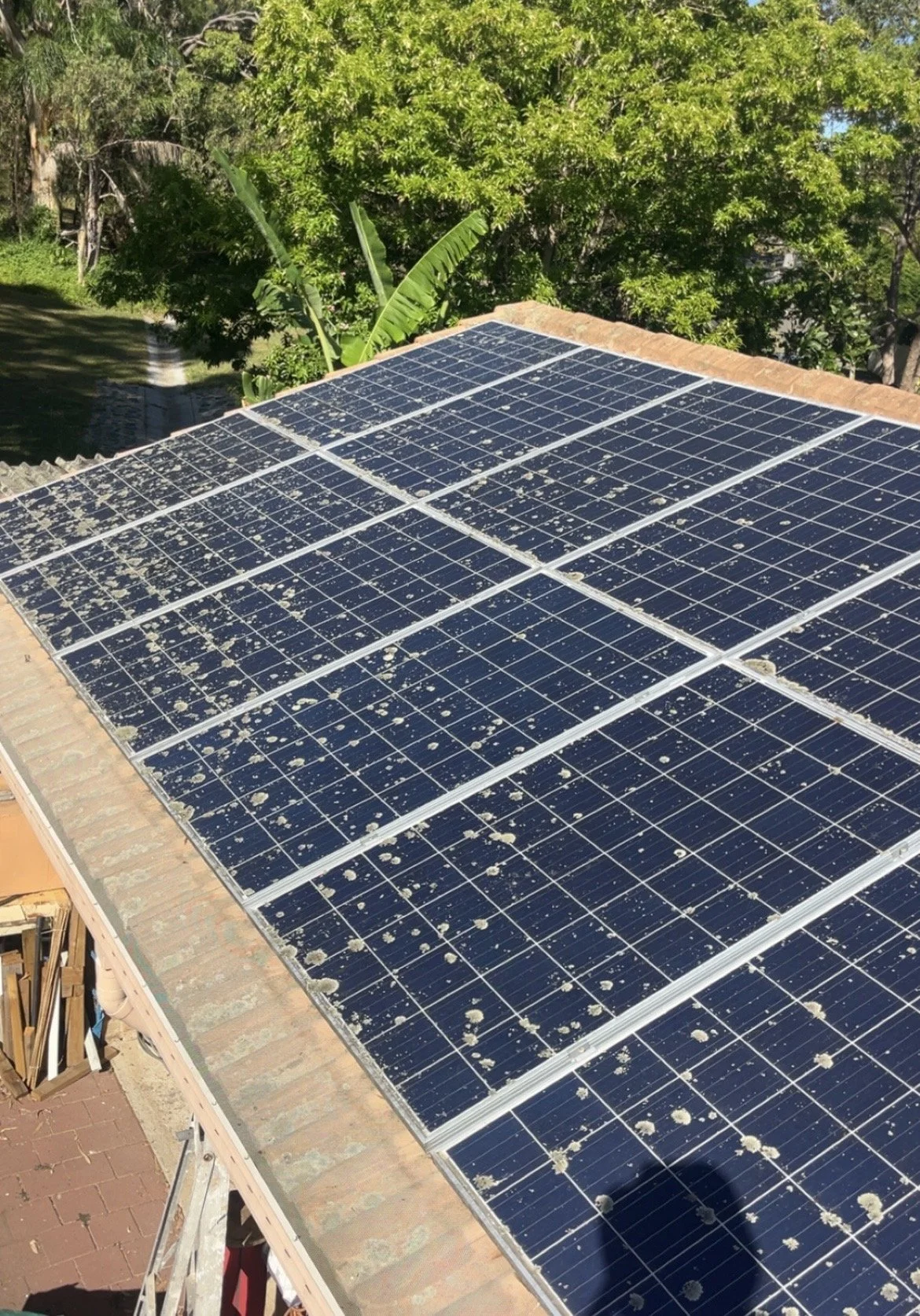 Solar panels being cleaned on a residential roof in Townsville Queensland