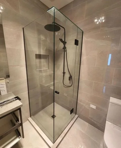 Frameless glass shower screen with a modern, sleek design, providing a spacious feel and easy maintenance. Perfect for bathrooms aiming for a clean, minimalist look.